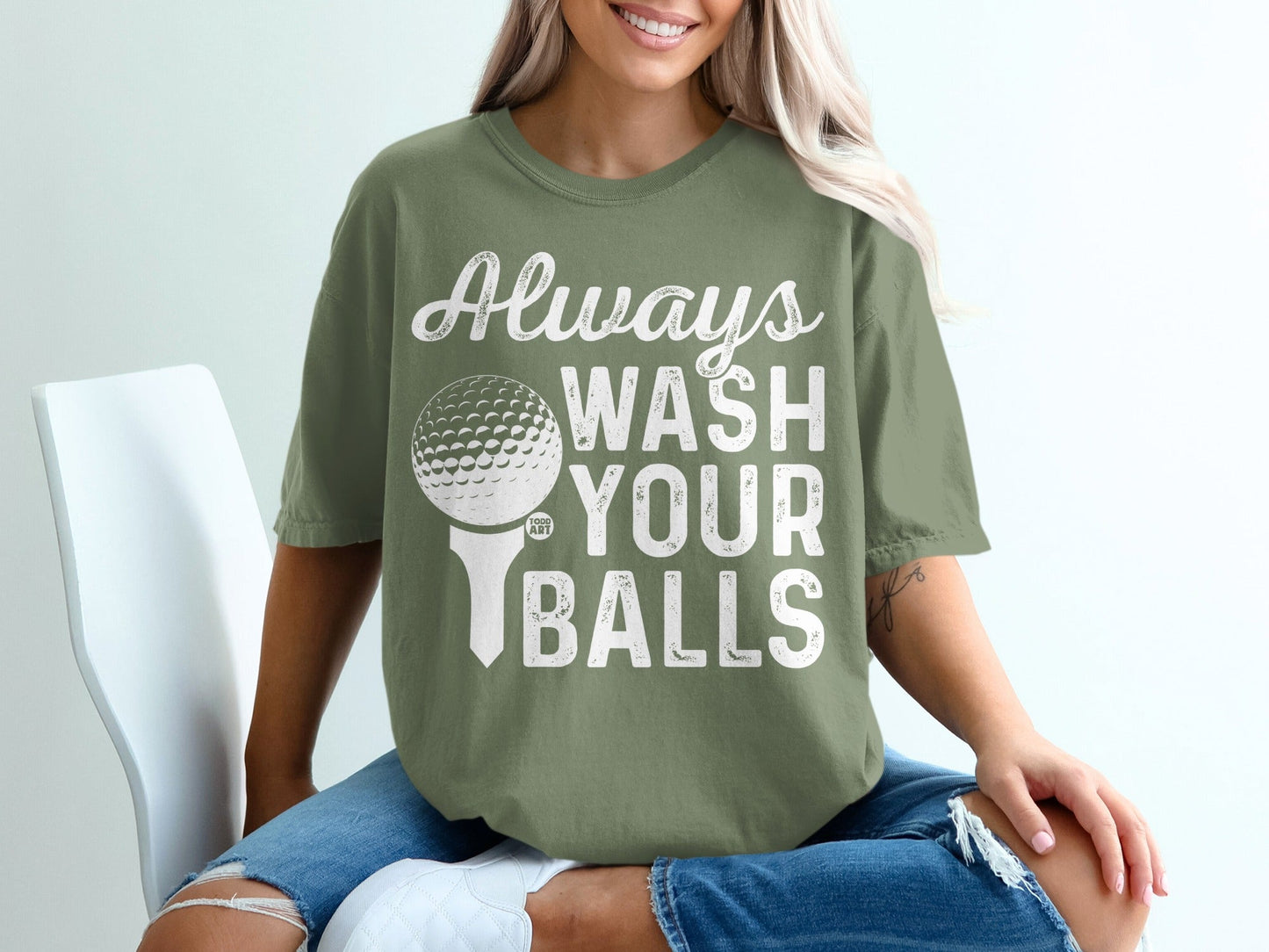 Olive green t-shirt with "Always Wash Your Balls" text and a golf ball on a tee.