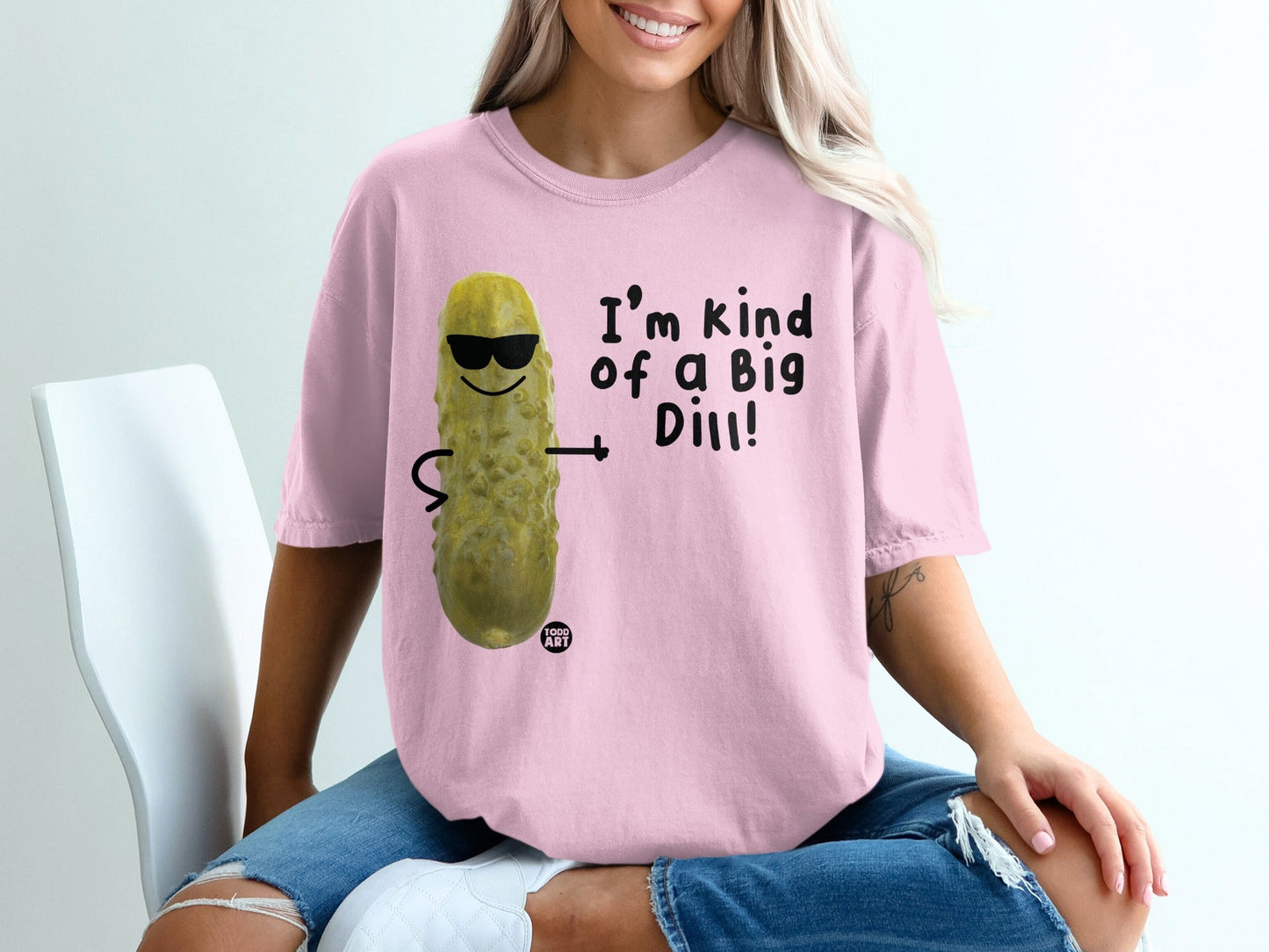 Pink t-shirt with cartoon pickle wearing sunglasses and "I'm kind of a big dill!" text.