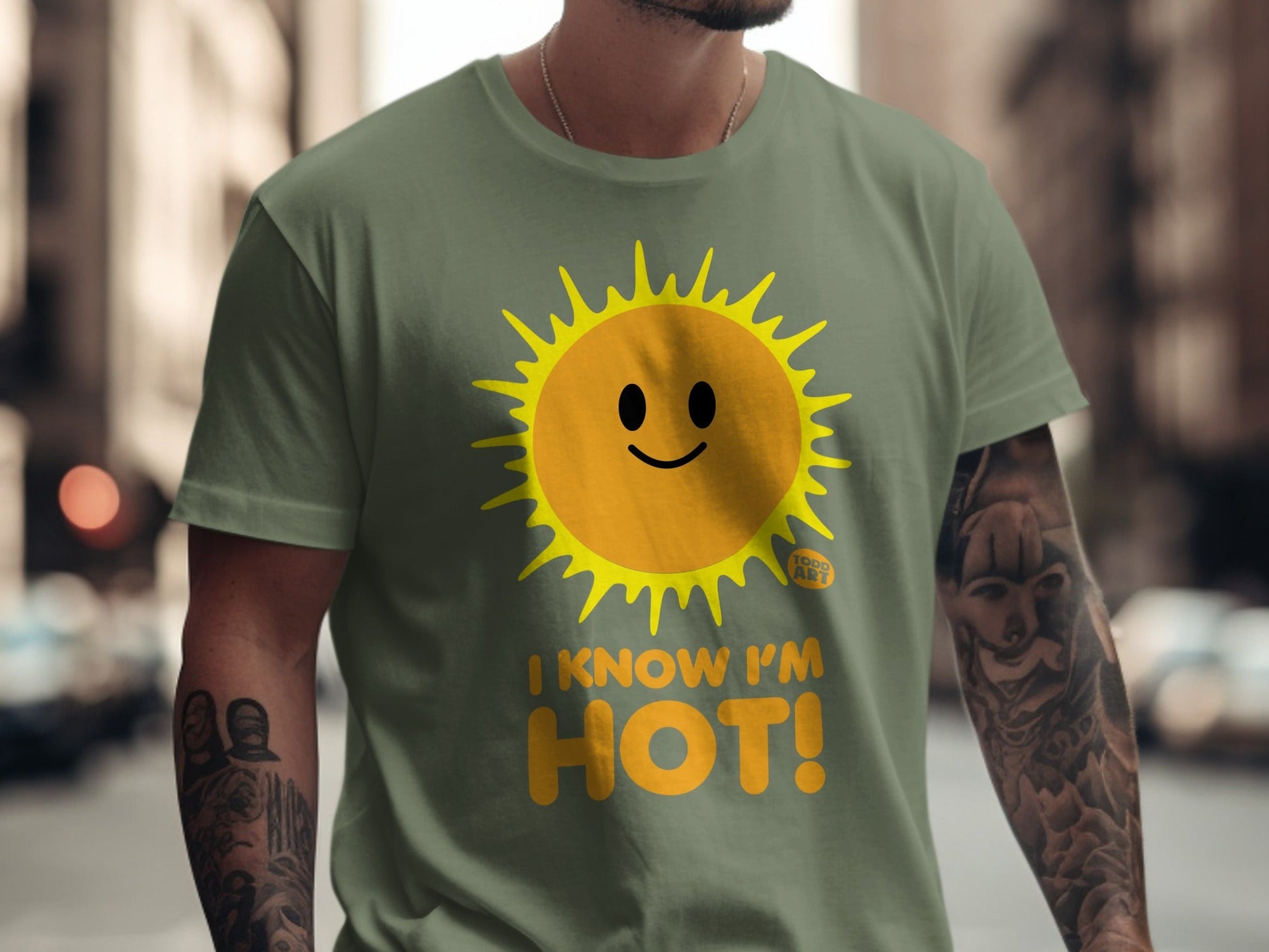 Green t-shirt with a smiley sun graphic and the text "I KNOW I'M HOT!".