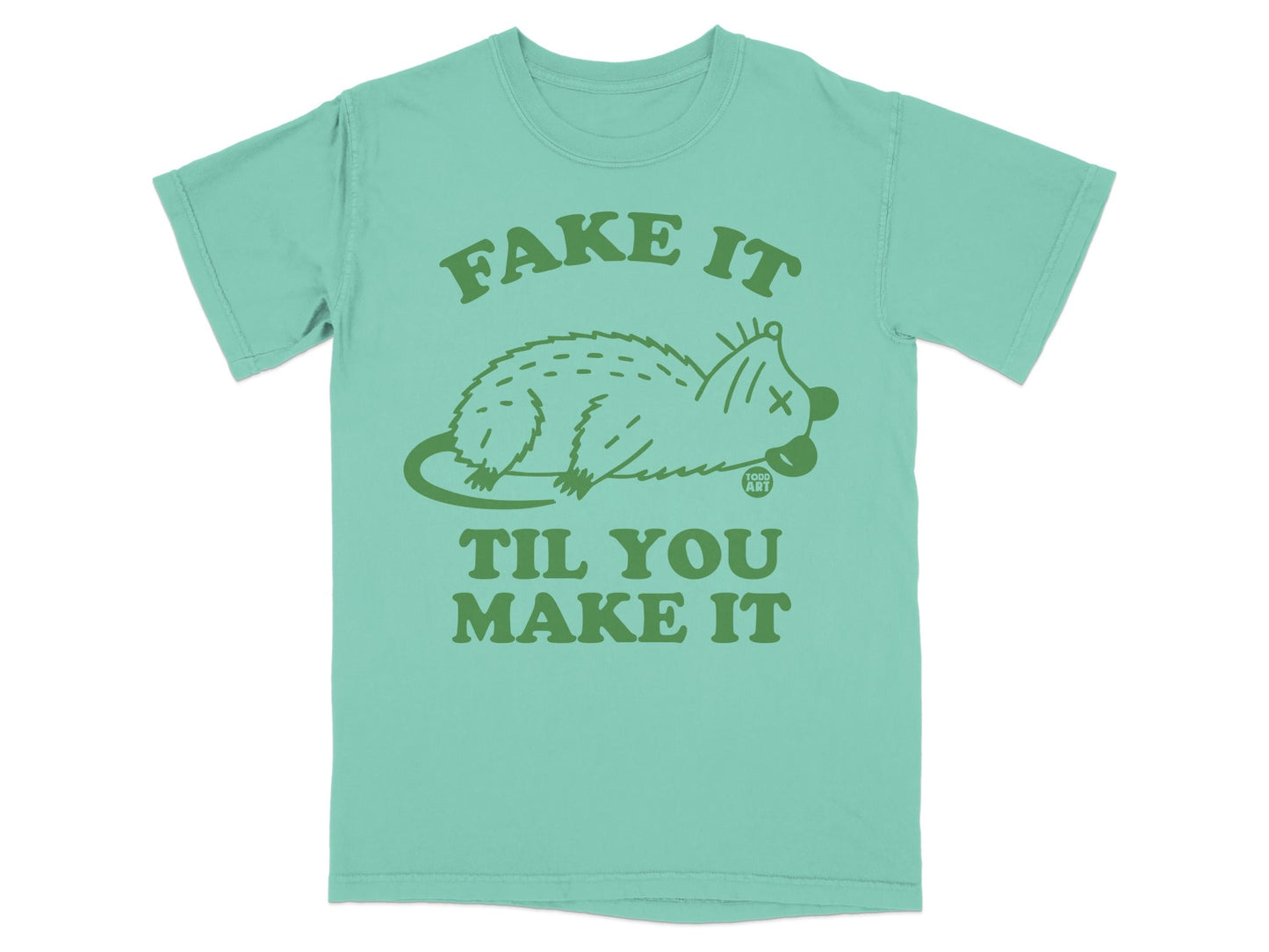 Mint green t-shirt with "Fake It Til You Make It" and a stylized opossum.