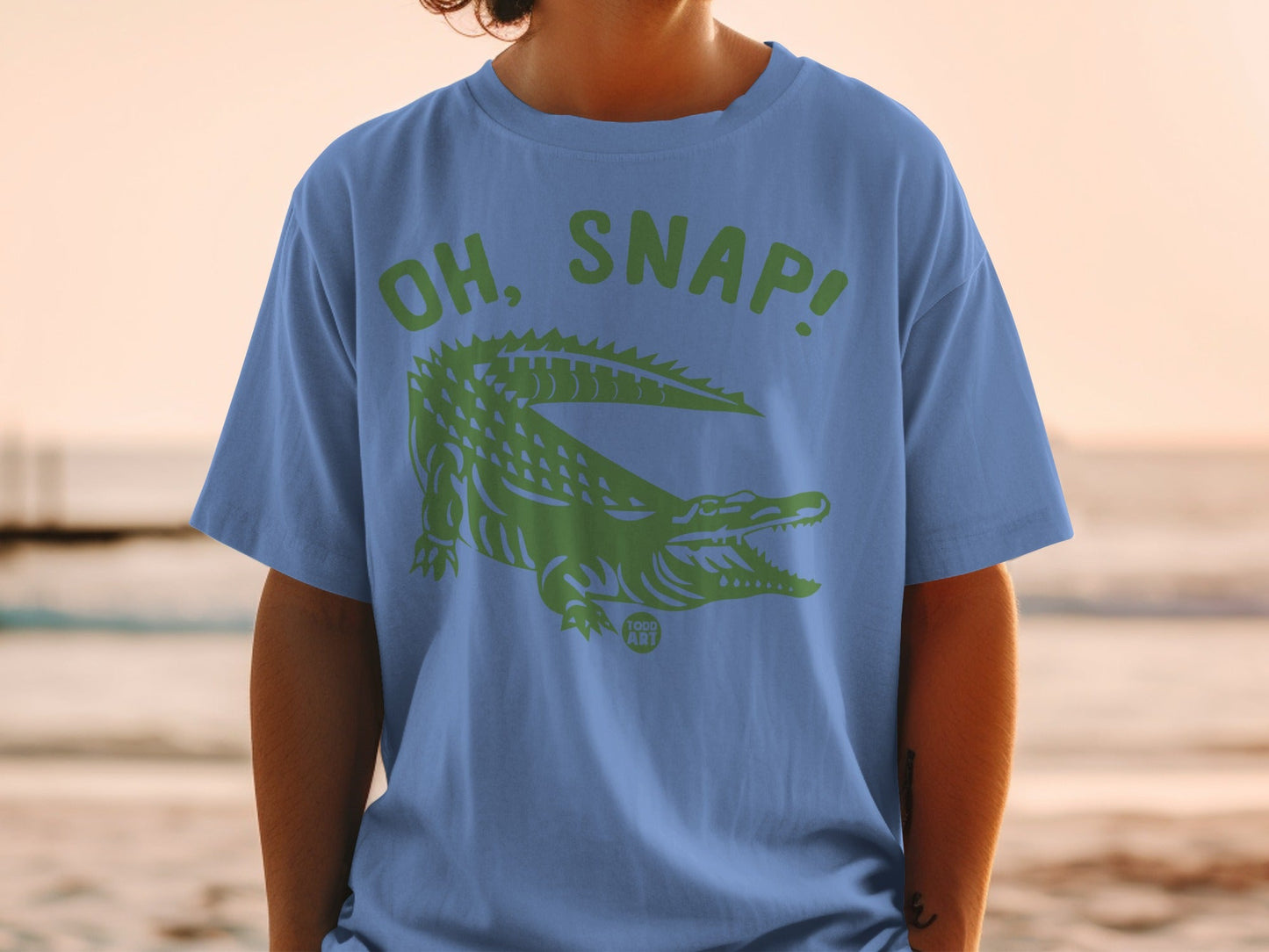 Blue t-shirt with green alligator and "OH, SNAP!" text.