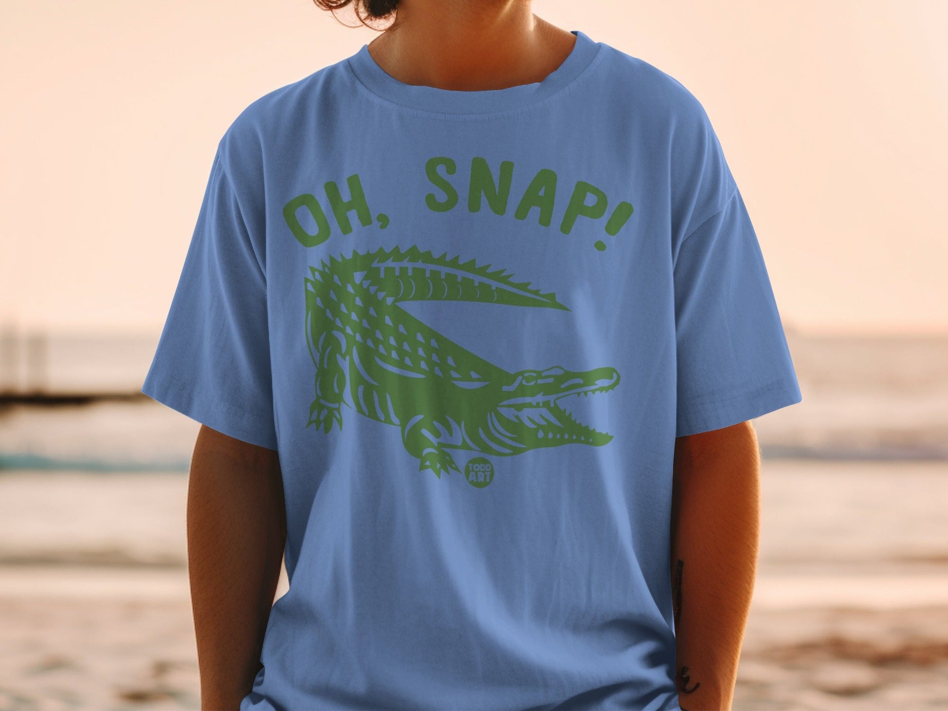Blue t-shirt with green alligator and "OH, SNAP!" text.