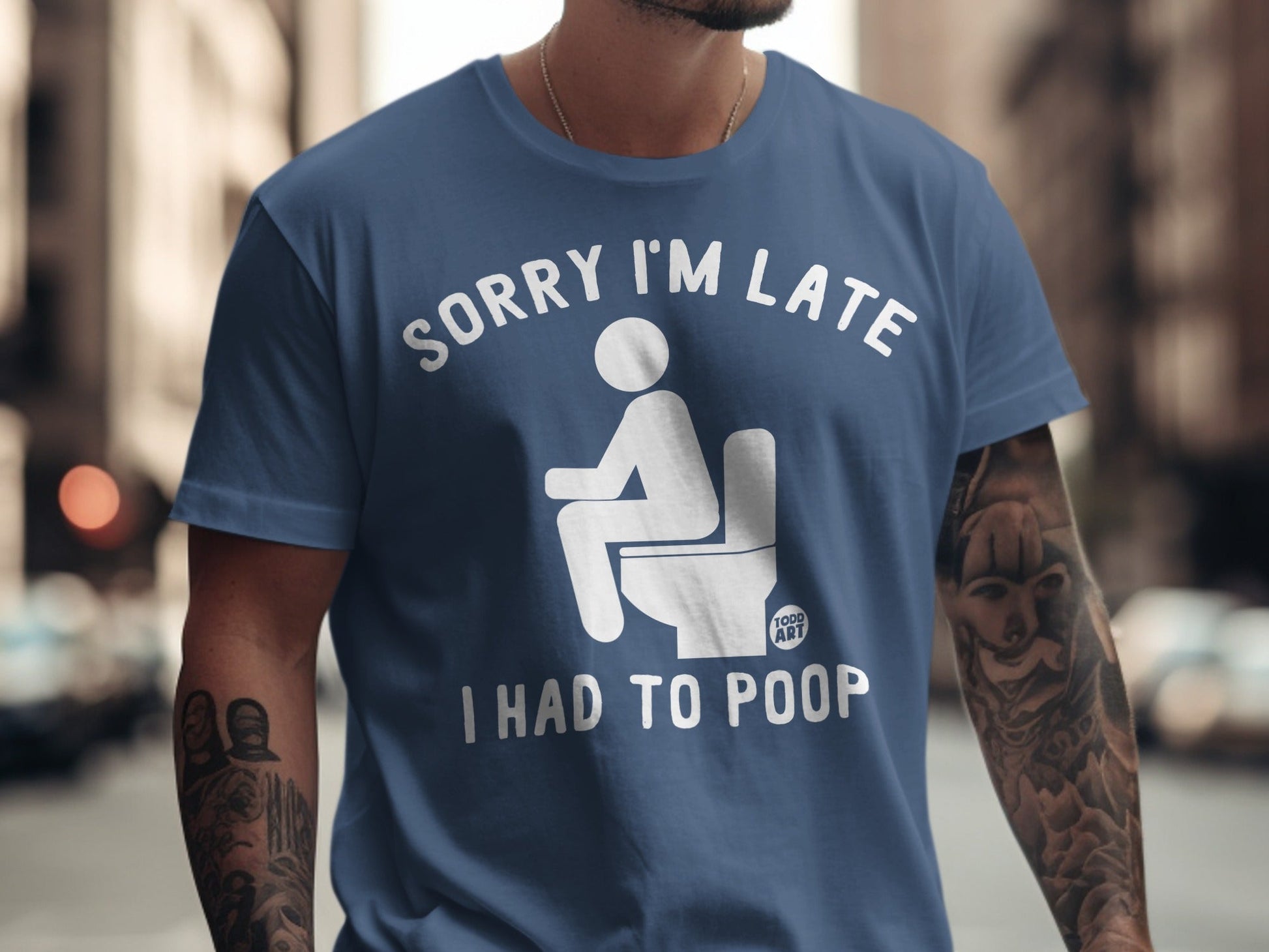 Blue t-shirt with "Sorry I'm Late I Had To Poop" text and toilet graphic.