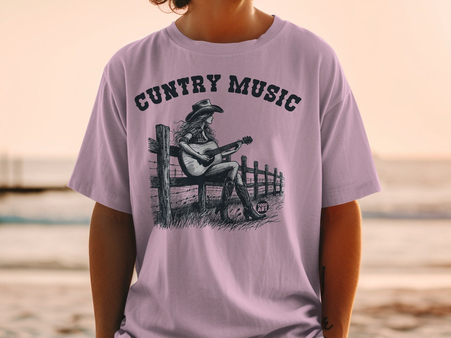 T-shirt with "Country Music" text and illustration of woman playing guitar.