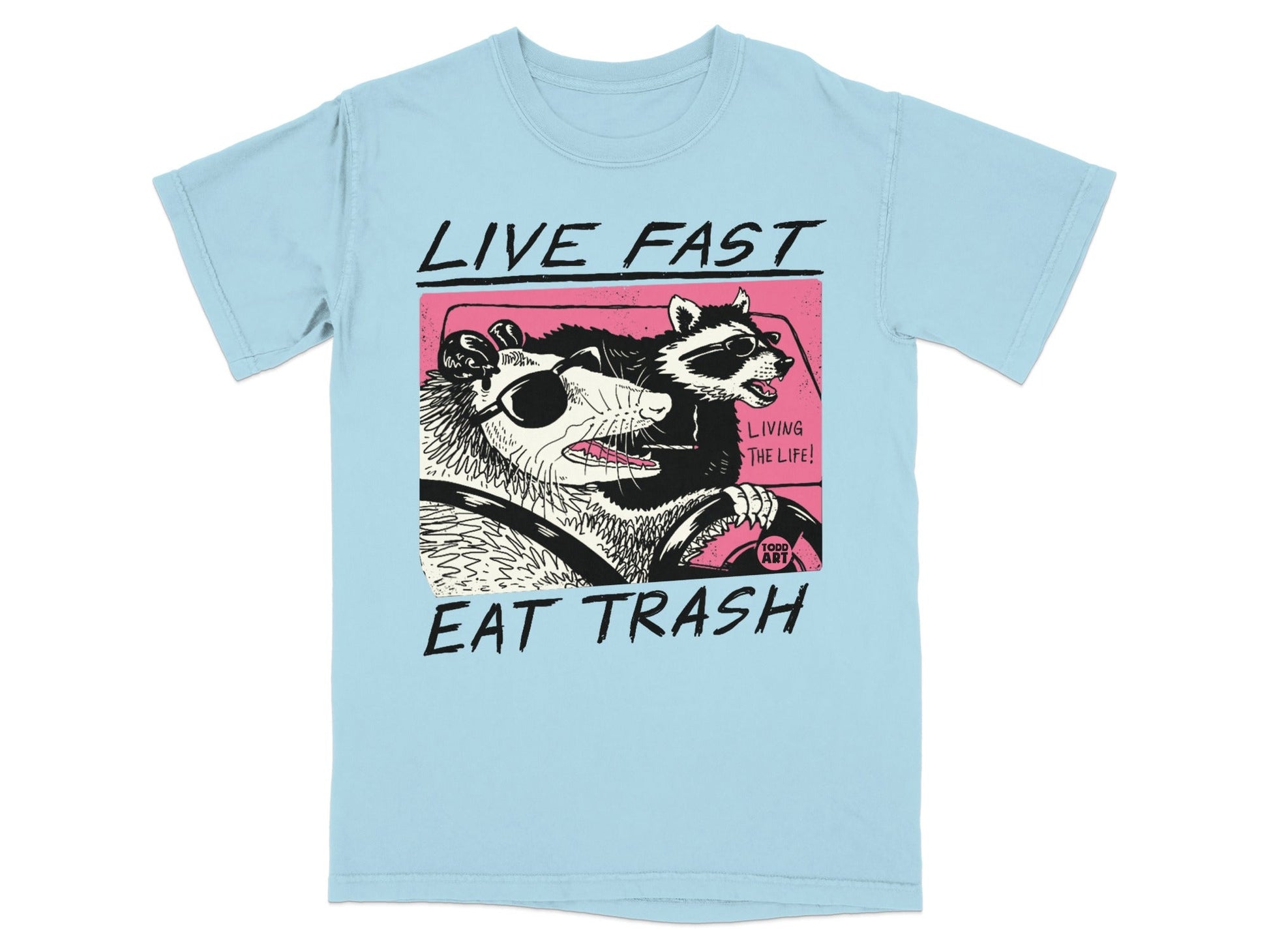 Light blue t-shirt with graphic of a possum and raccoon driving a car.