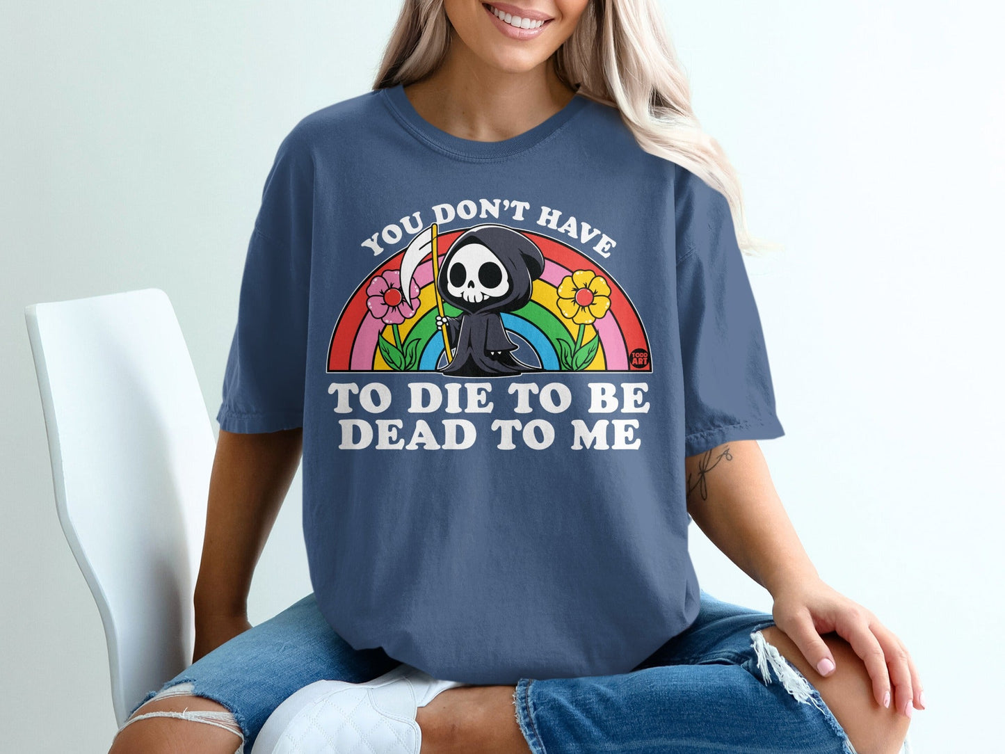 T-shirt with grim reaper, rainbow, flowers, and text.