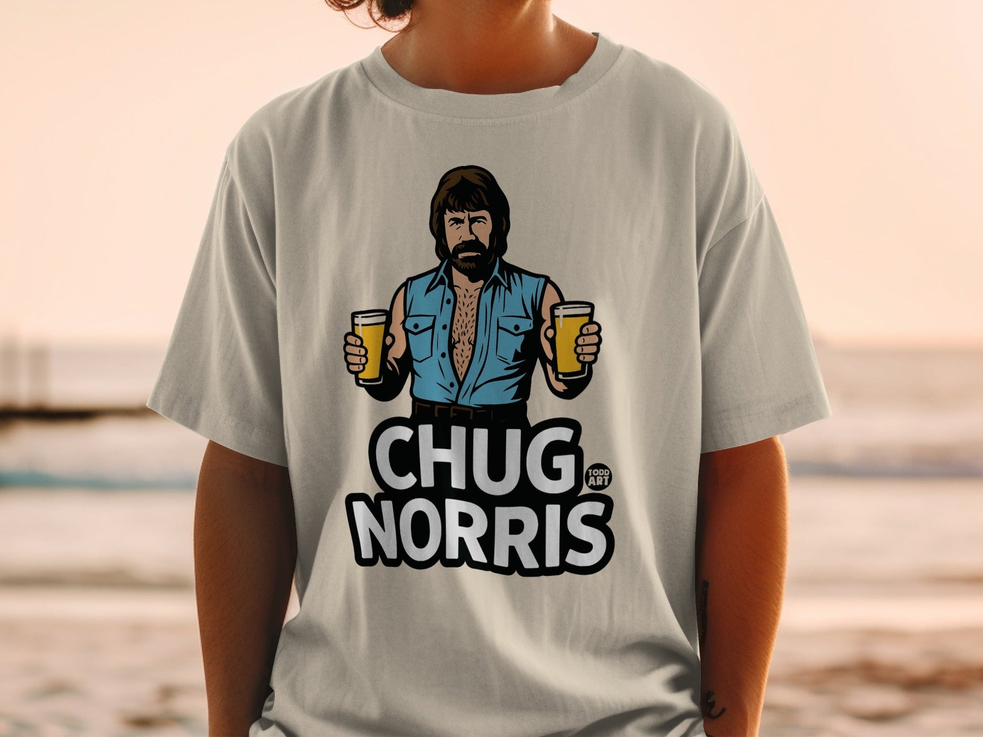 T-shirt with Chuck Norris illustration holding two beers, text reads "CHUG NORRIS".