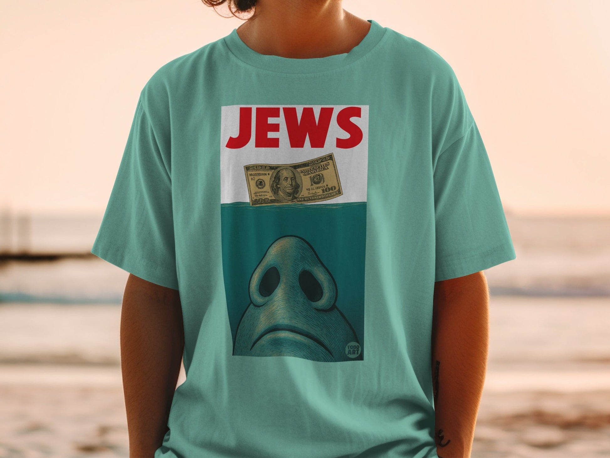 T-shirt with "JEWS" text and a shark fin above a $100 bill.