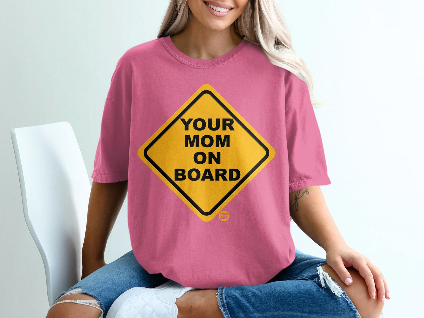 Pink t-shirt with yellow diamond warning sign that reads "YOUR MOM ON BOARD".