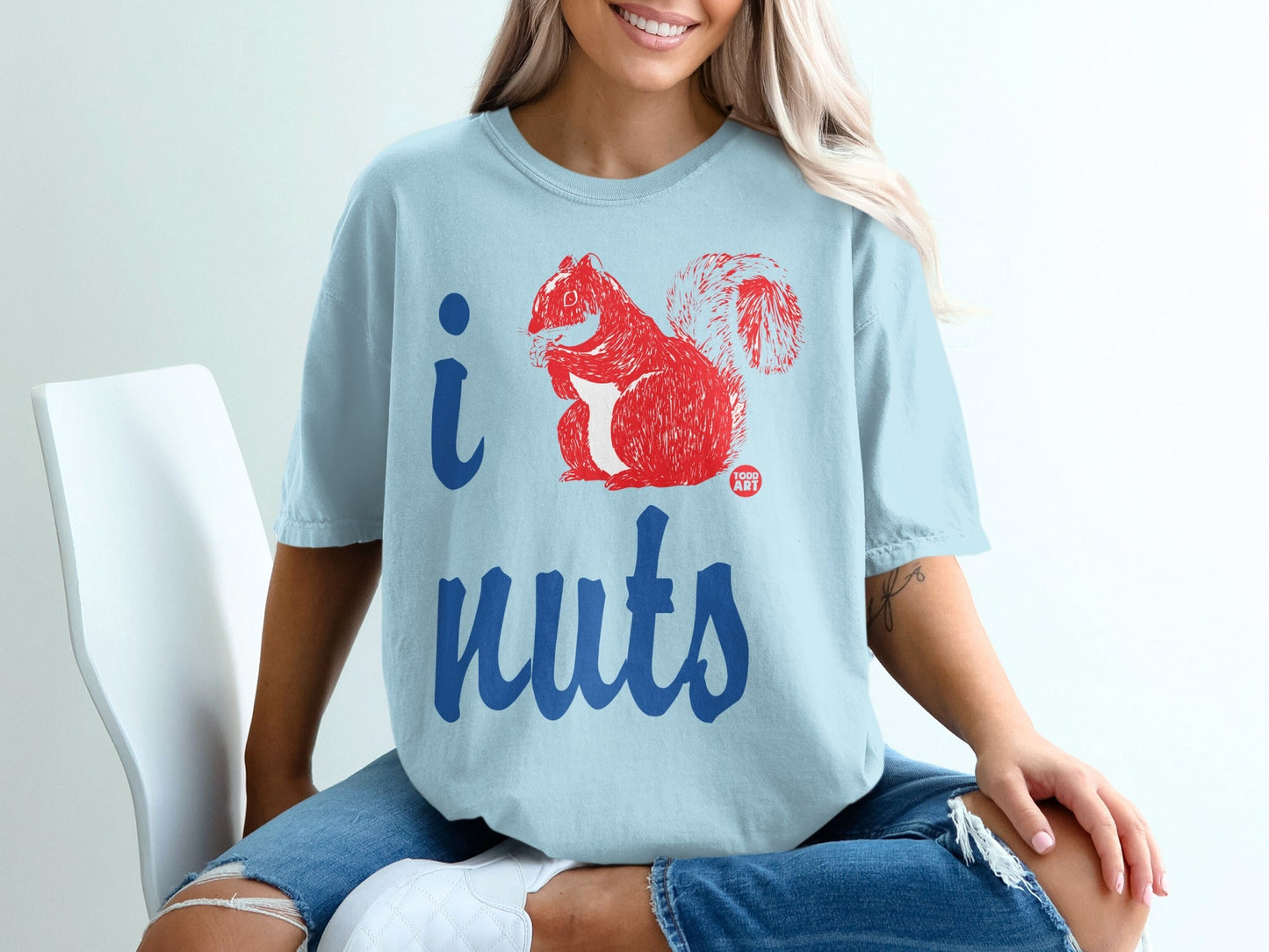 Light blue t-shirt with "i nuts" and a red squirrel graphic.