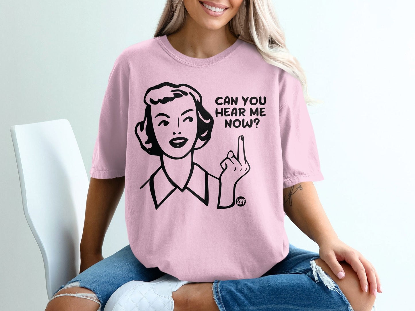 Pink t-shirt with retro graphic and text "Can You Hear Me Now?".