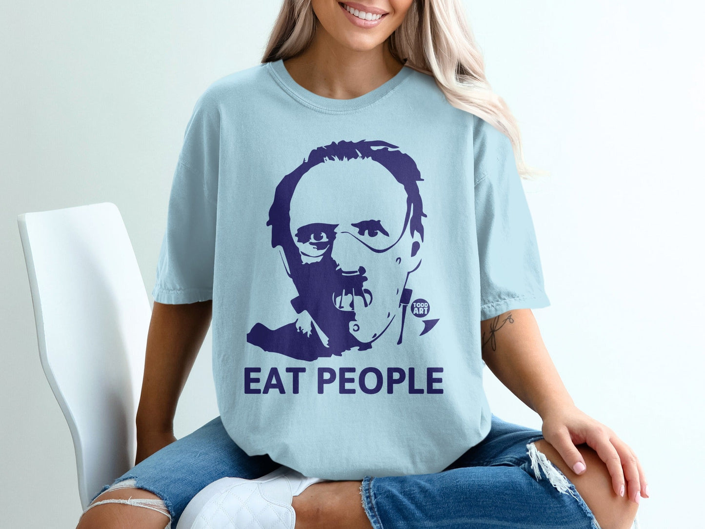 Light blue t-shirt with dark blue graphic of Hannibal Lecter saying "EAT PEOPLE".