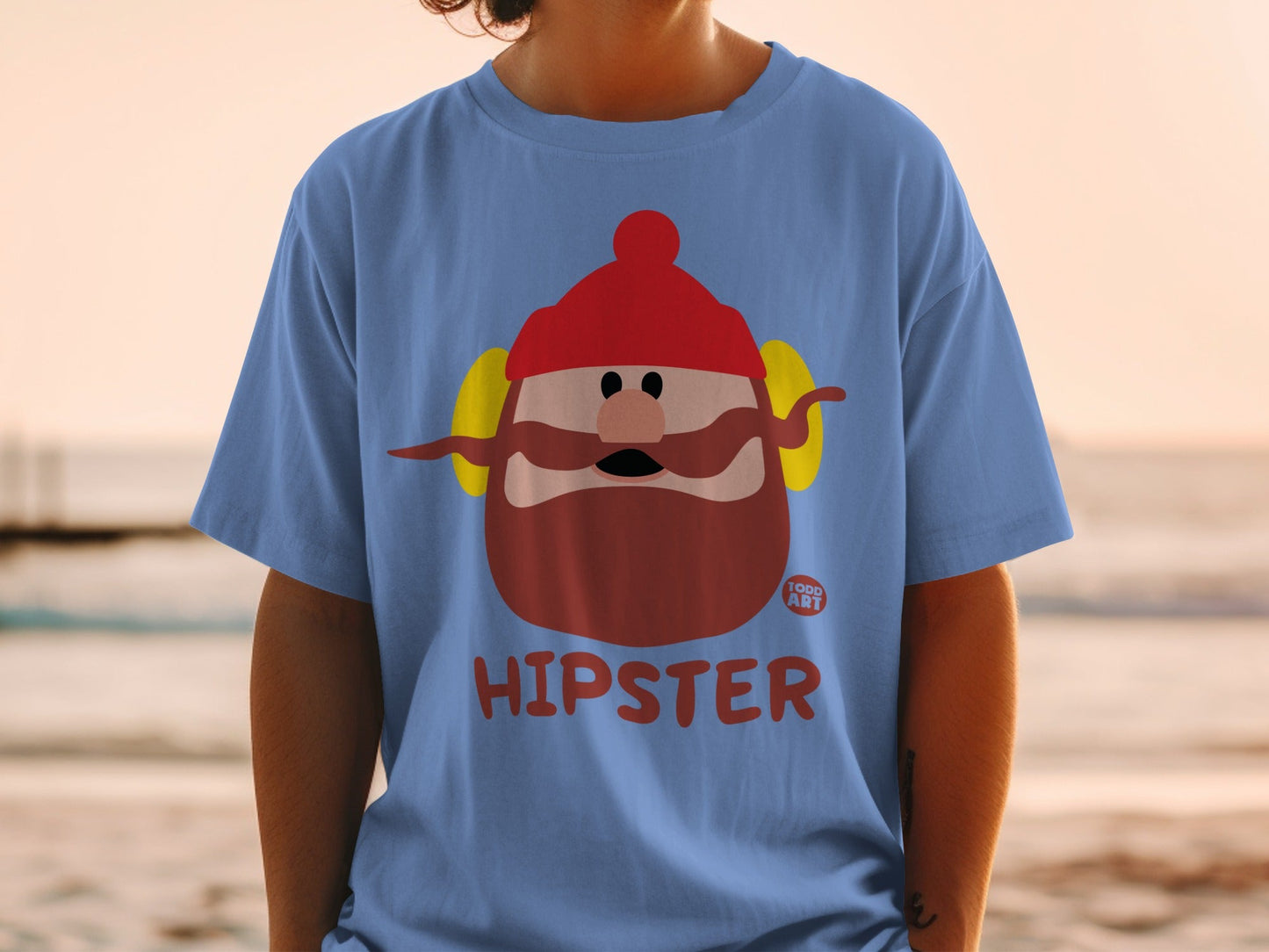 Blue t-shirt with cartoon hipster character wearing red hat and earmuffs.