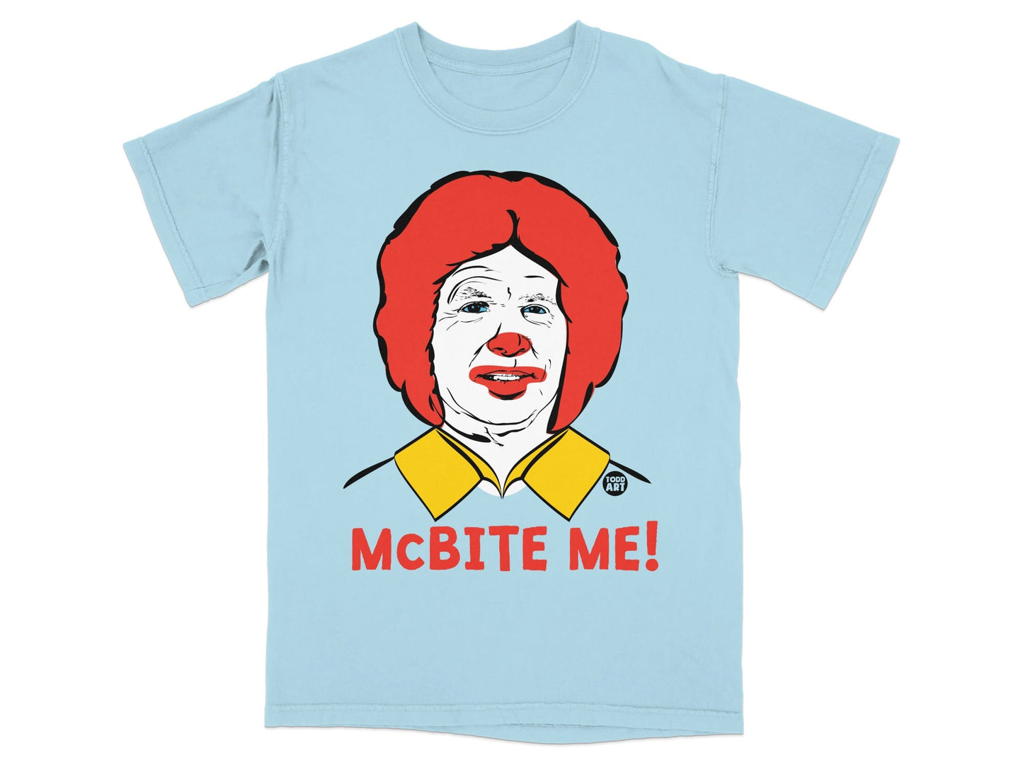 Light blue t-shirt featuring a caricature of Ronald McDonald and the text "MCBITE ME!".