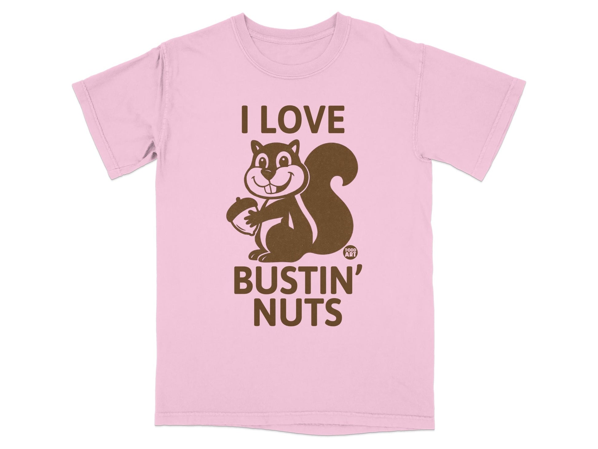 Pink t-shirt with a cartoon squirrel holding an acorn and the text "I LOVE BUSTIN' NUTS".