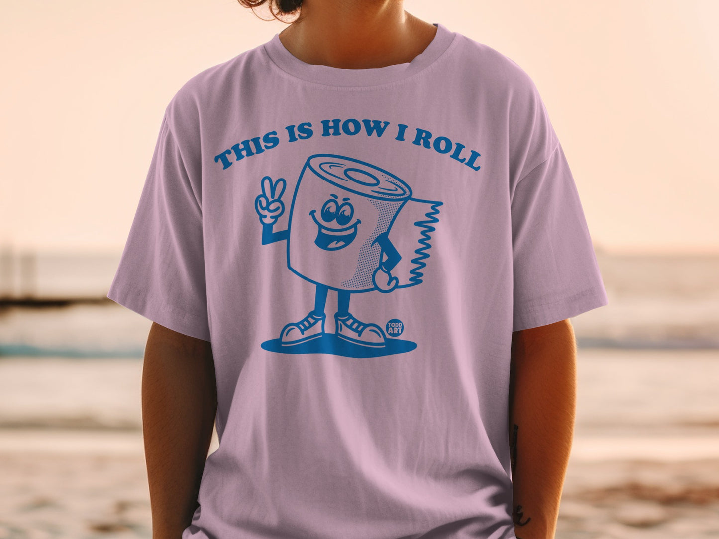Light purple t-shirt with a cartoon toilet paper roll giving a peace sign.