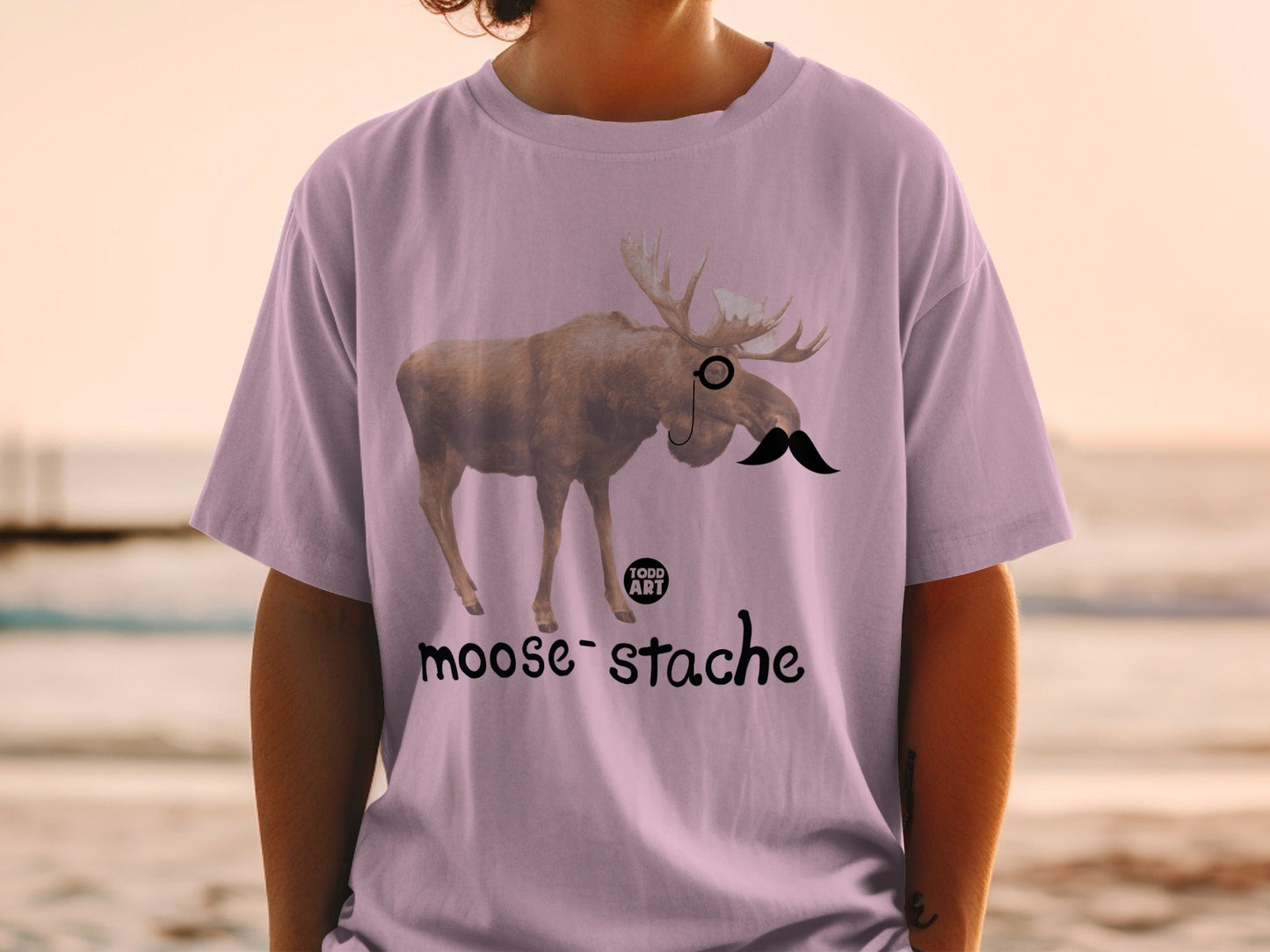 Moose wearing a monocle and mustache, text "moose-stache"