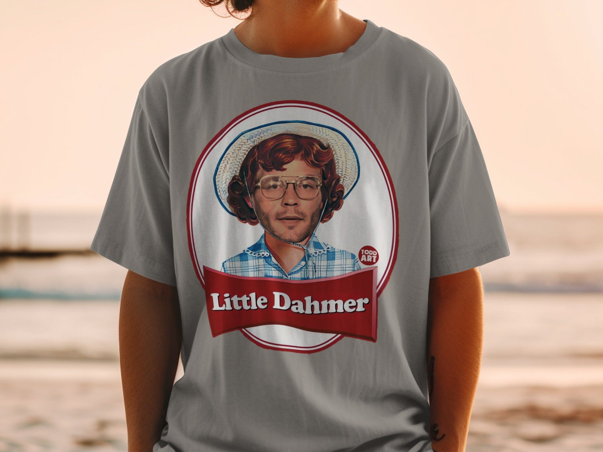 T-shirt with a circular portrait of a man wearing a straw hat and glasses.