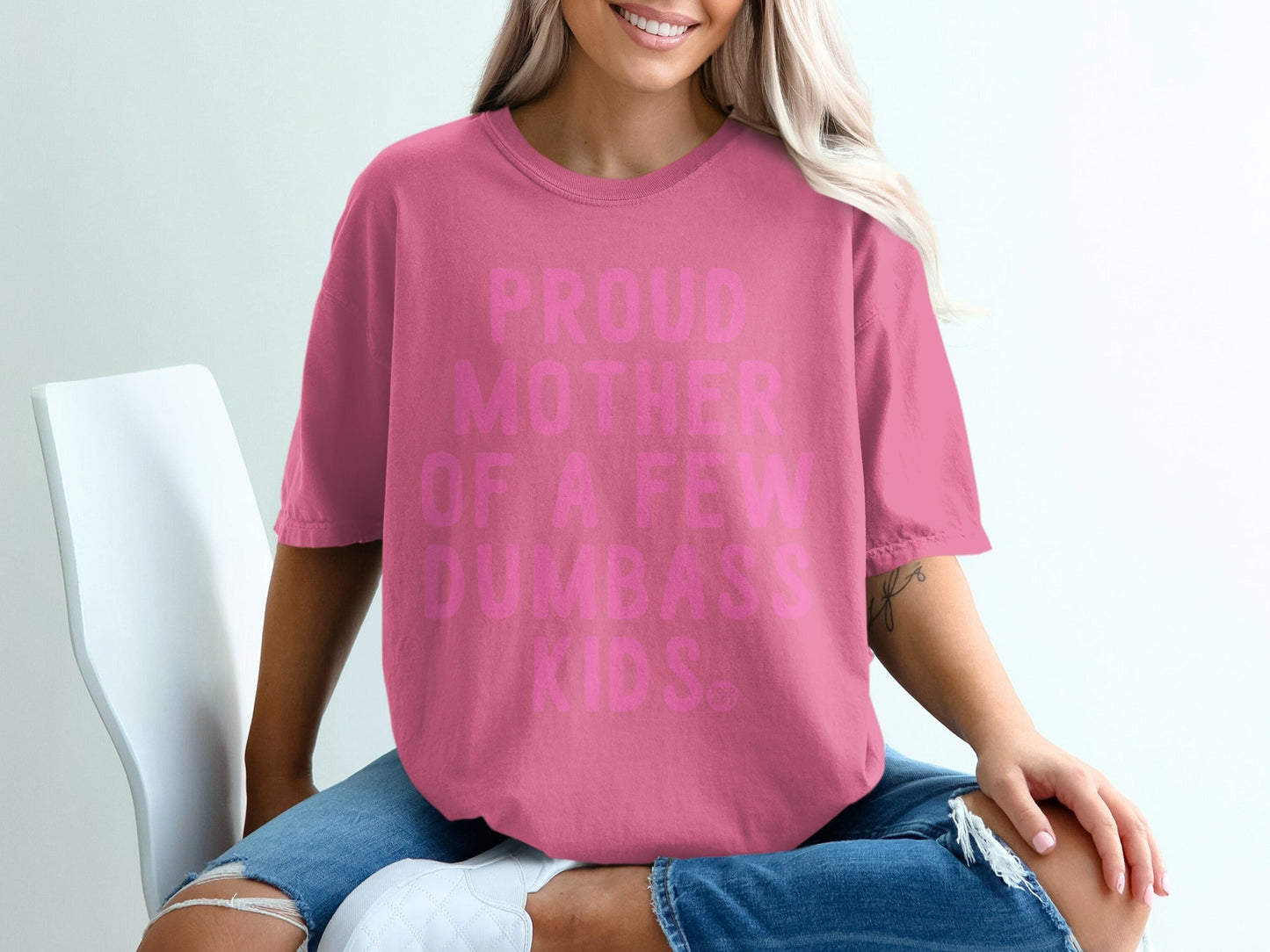 Pink t-shirt with "Proud Mother of a Few Dumbass Kids" text.