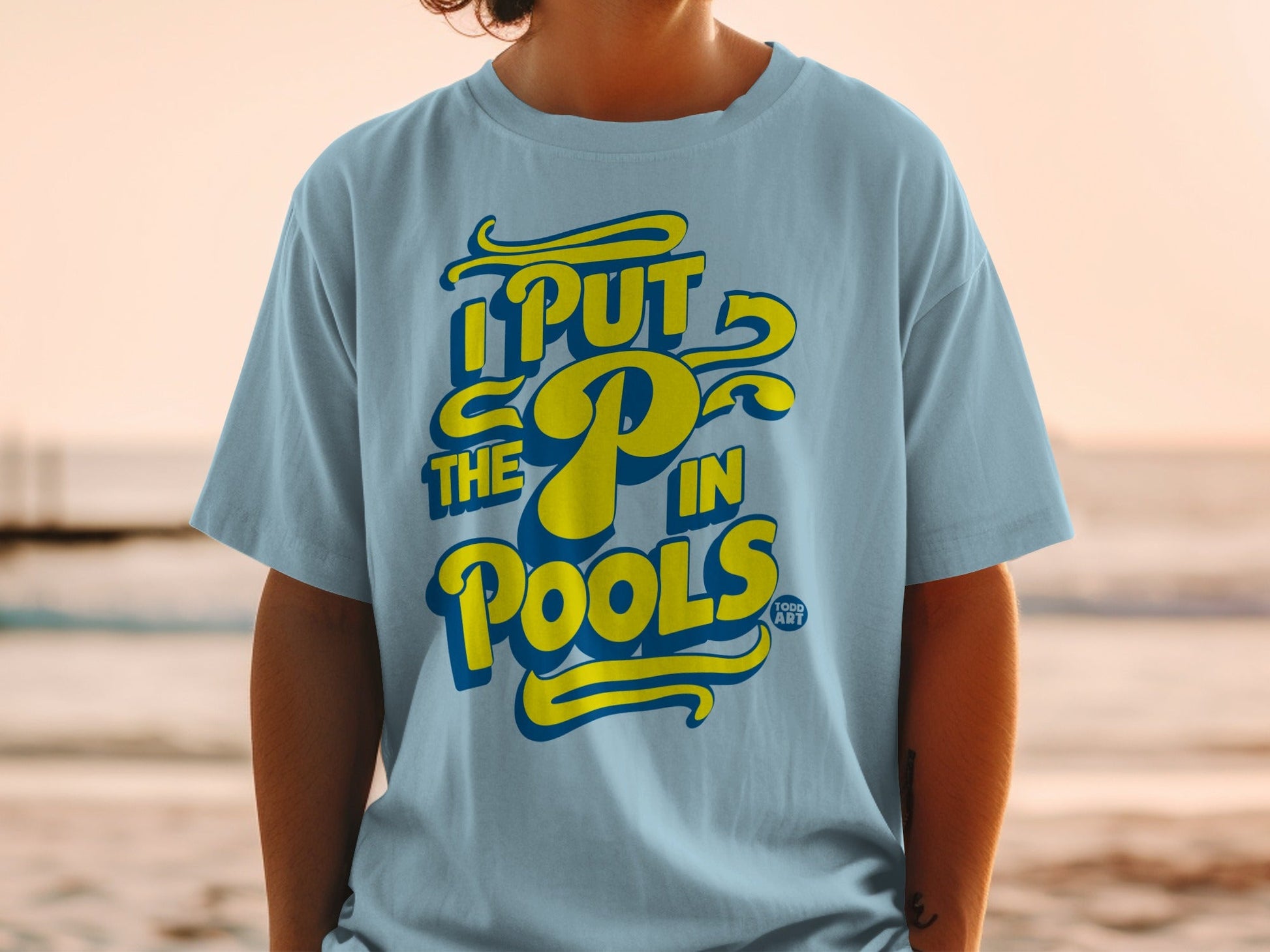 Blue t-shirt with yellow text "I PUT THE P IN POOLS".