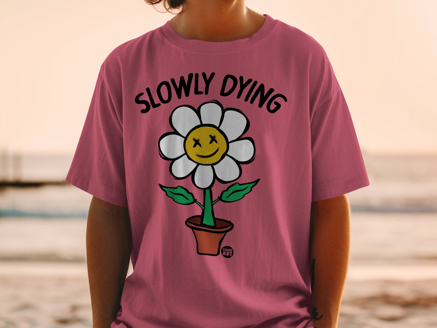 Pink t-shirt with a potted flower wearing sunglasses and a smiley face.