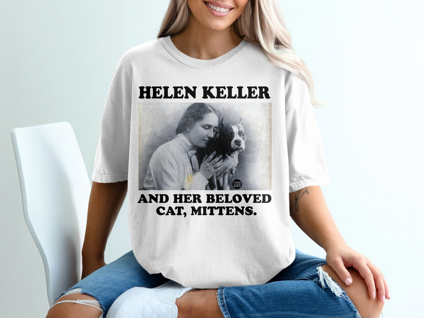 T-shirt with "Helen Keller and her beloved cat, Mittens" text and vintage portrait.