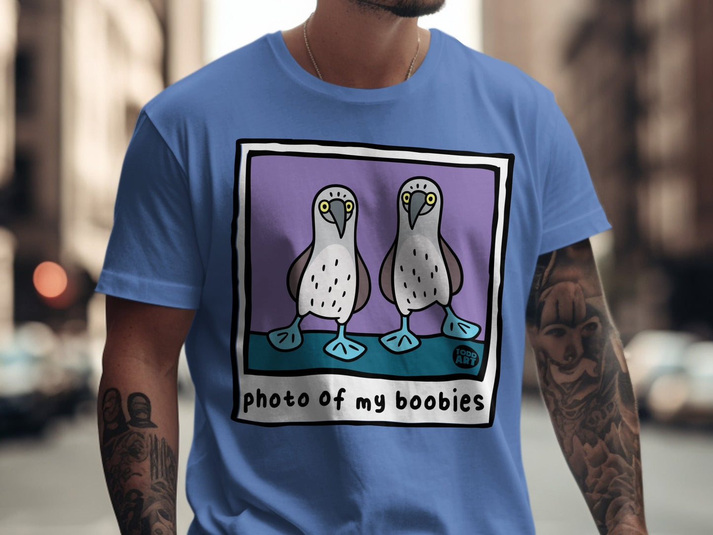 Blue t-shirt featuring cartoon boobies with text "photo of my boobies" and "TODD ART".
