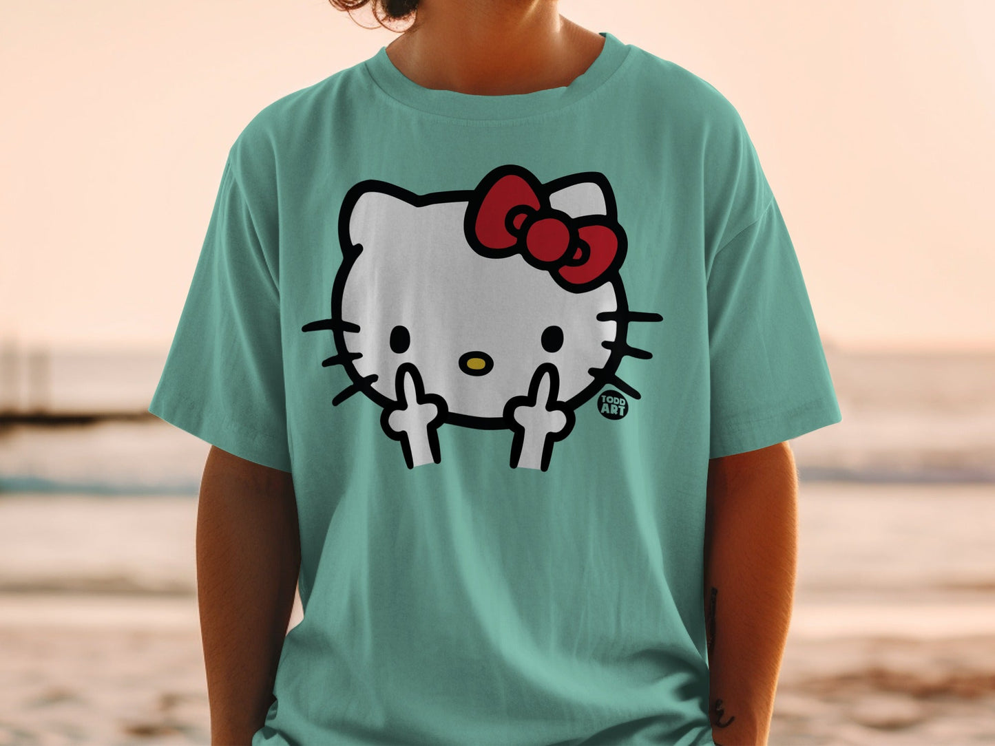 Teal t-shirt with Hello Kitty wearing a red bow, giving the middle finger.