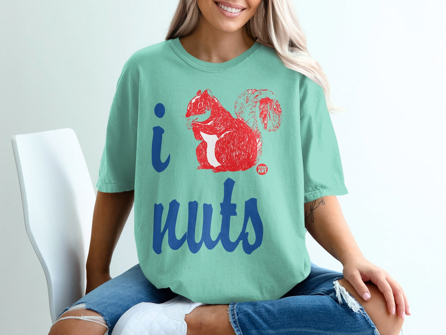 Teal t-shirt with "I ‚ù§Ô∏è nuts" graphic featuring a red squirrel.