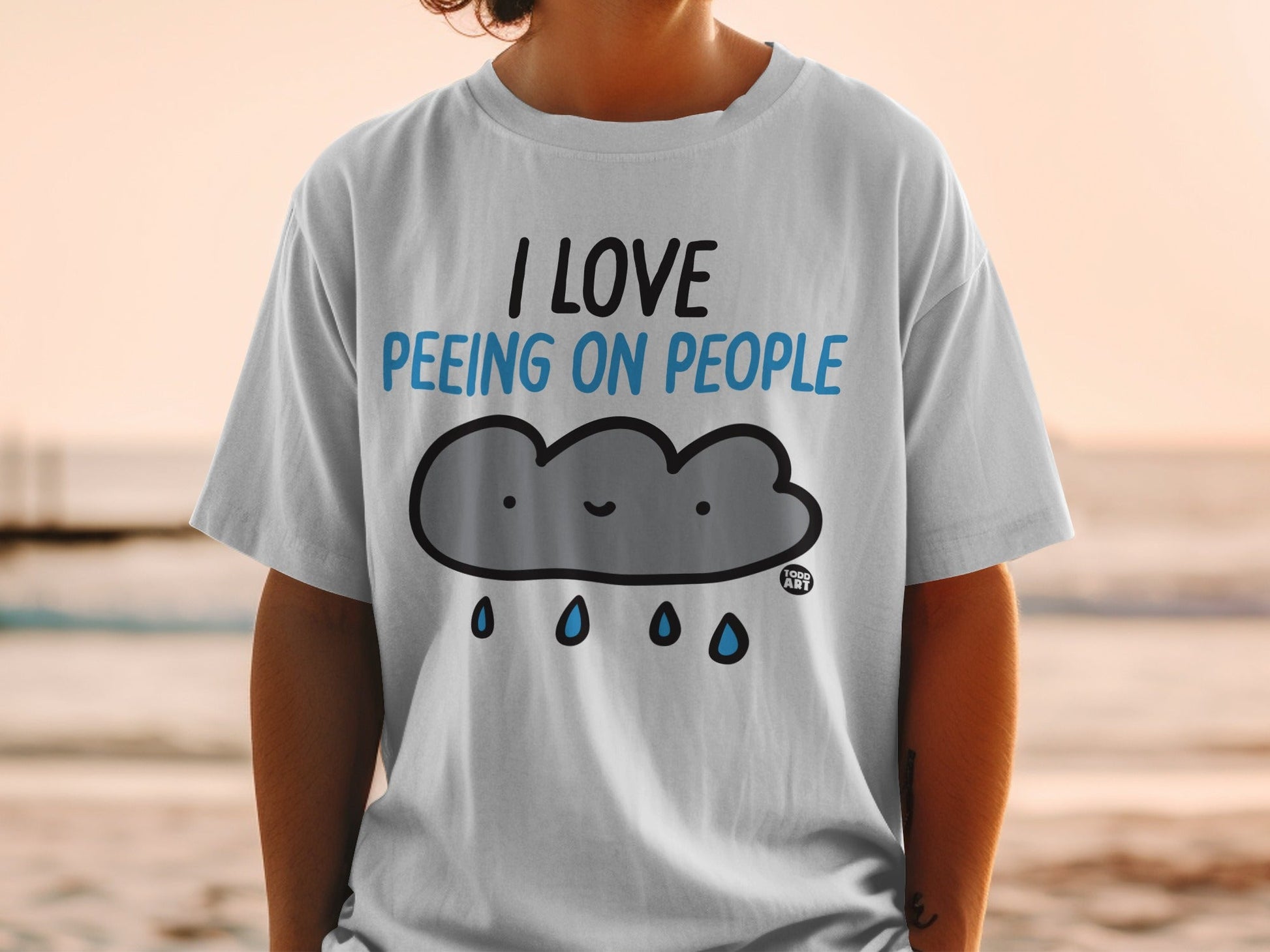 White t-shirt with "I love peeing on people" text and cartoon cloud.
