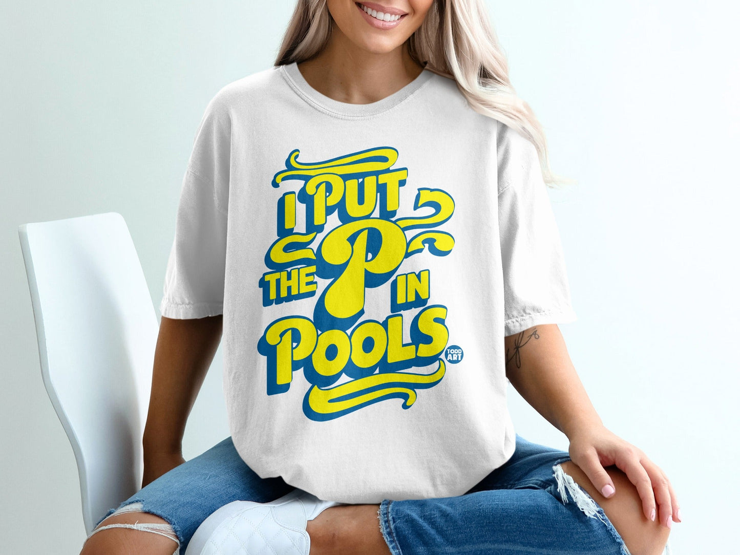 White t-shirt with blue and yellow text "I PUT THE P IN POOLS".