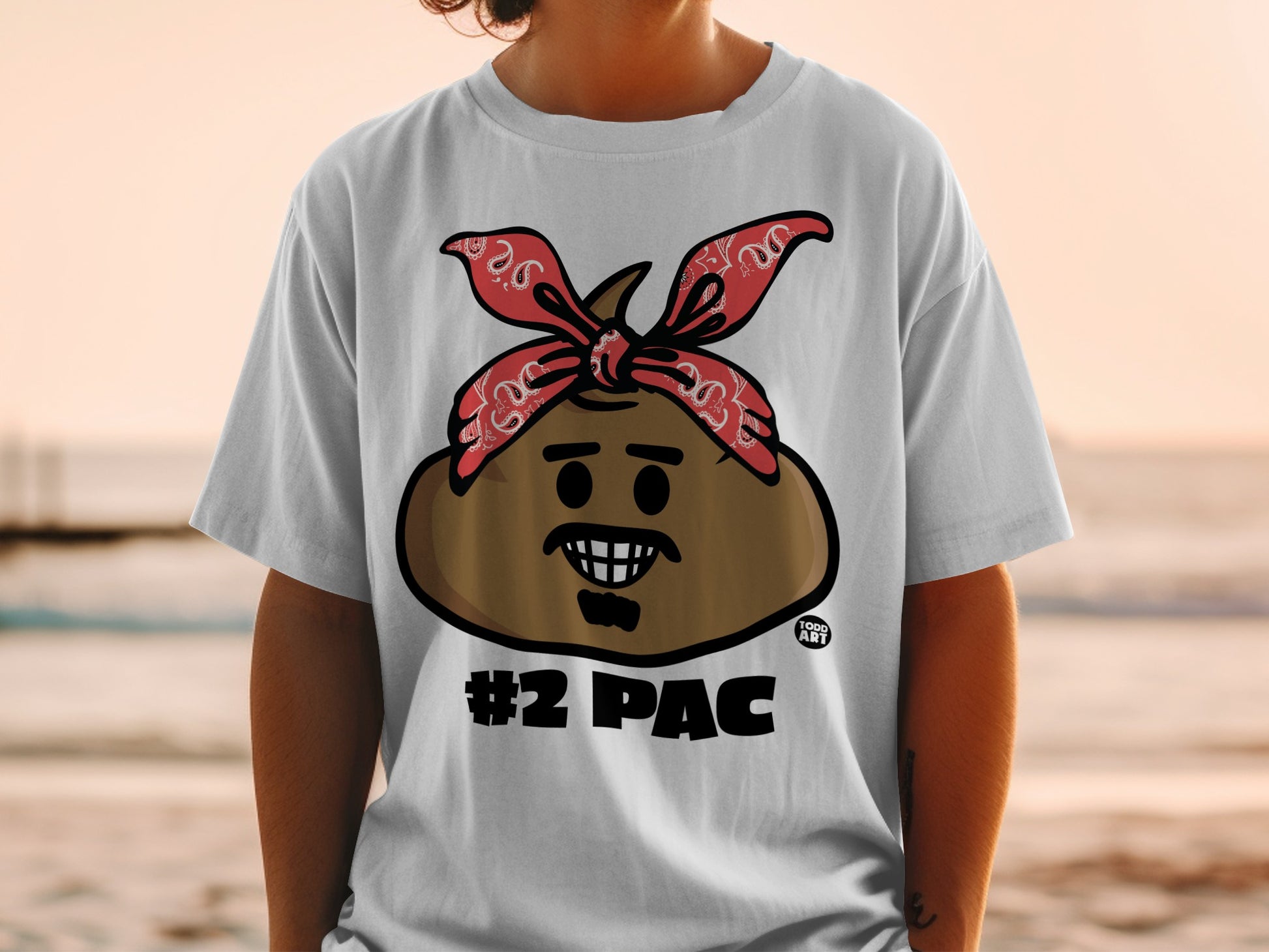 T-shirt with a smiling poop emoji wearing a red bandana, "#2 PAC" text.