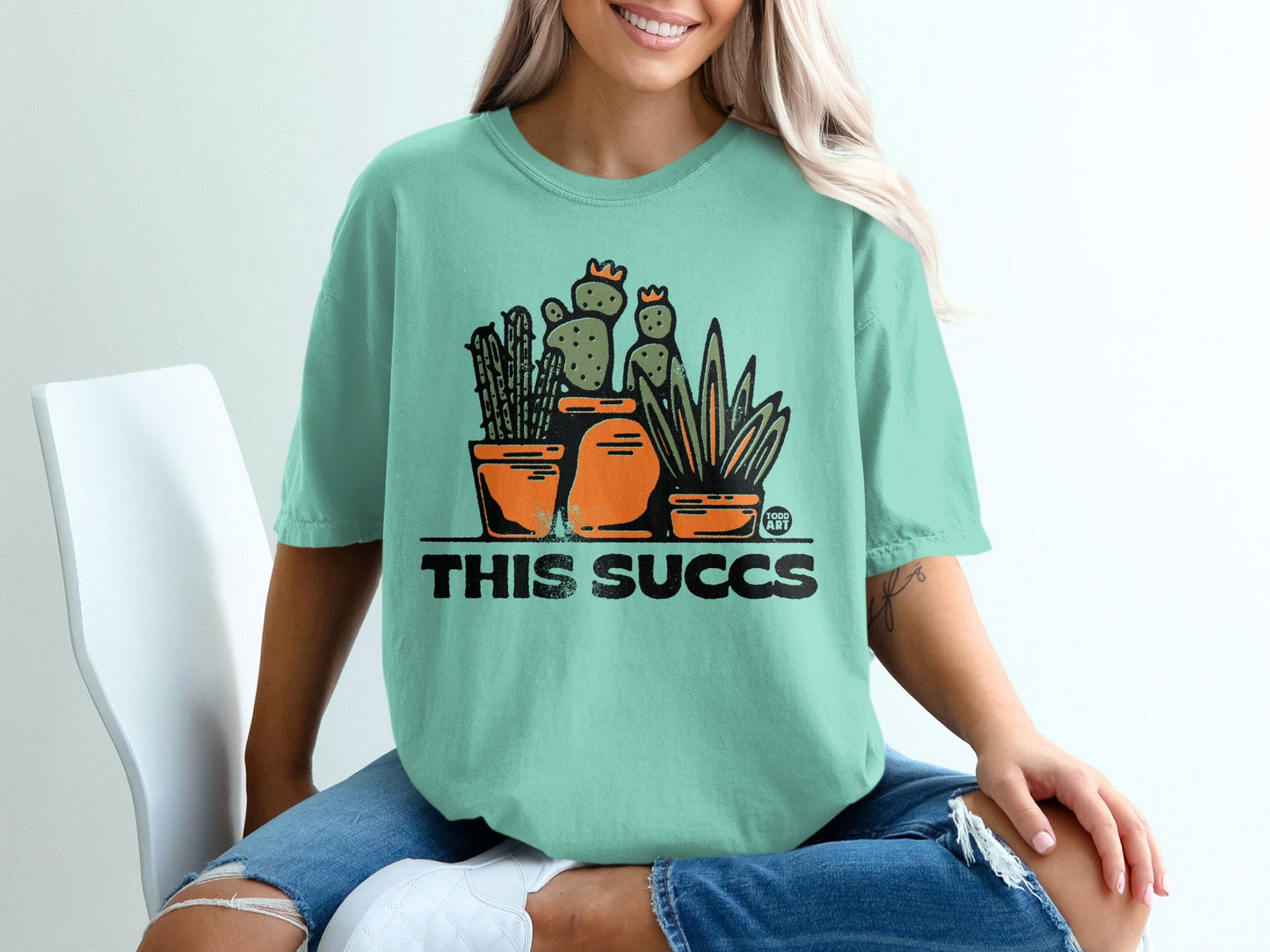 This Succs Graphic Tee with Cactus and Potted Plants Design