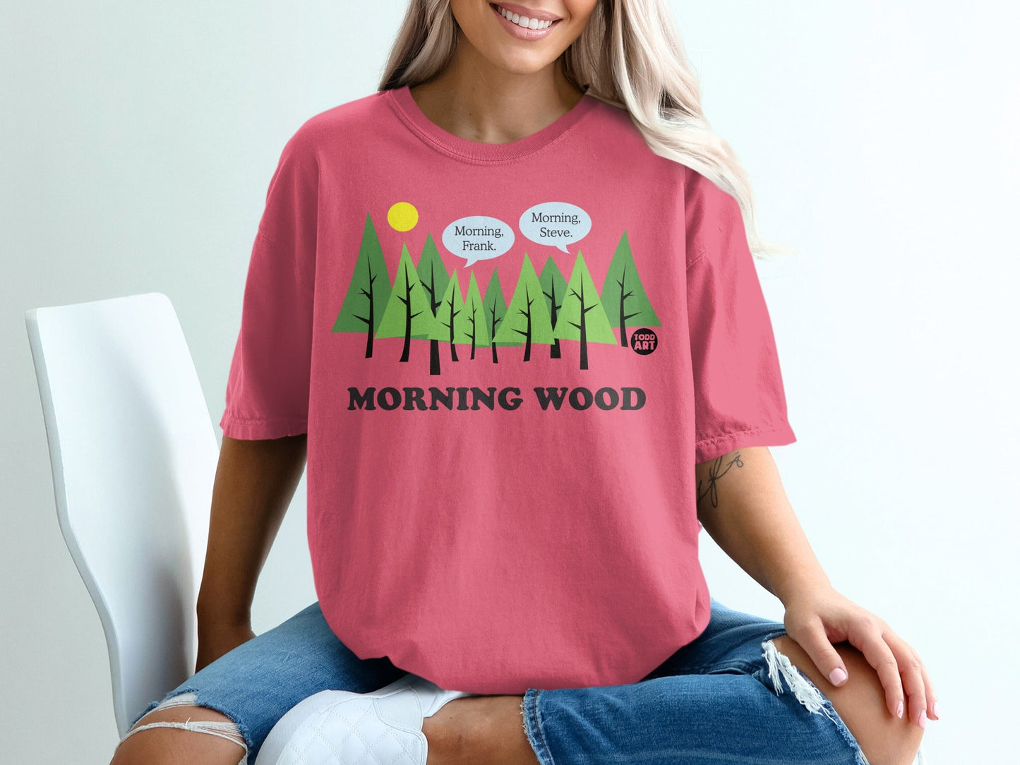 Pink t-shirt with trees, speech bubbles, and "MORNING WOOD" text.