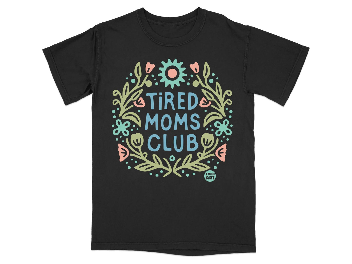 Black t-shirt with "Tired Moms Club" text and floral wreath design.