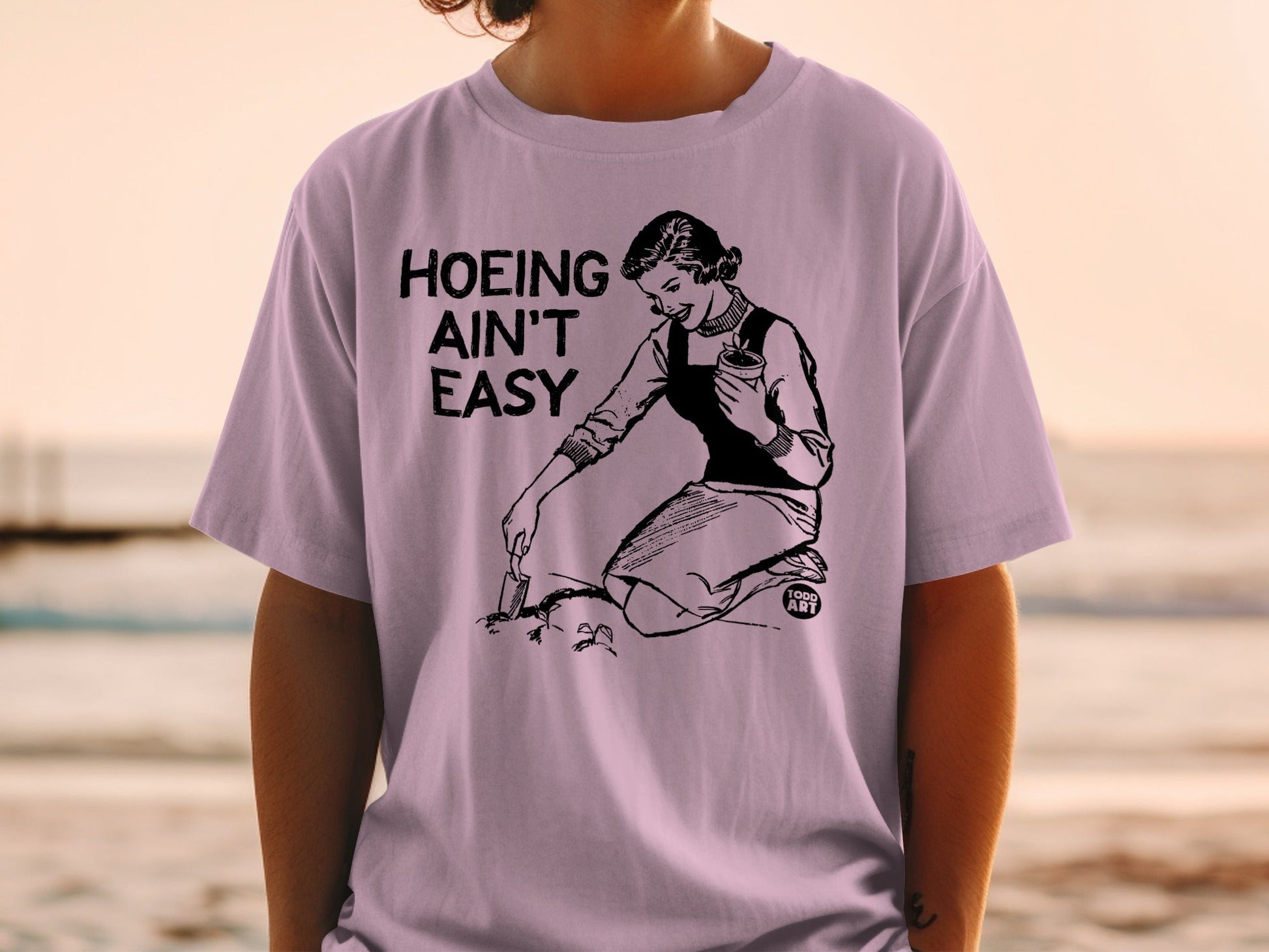 Woman gardening with text "Hoeing Ain't Easy".