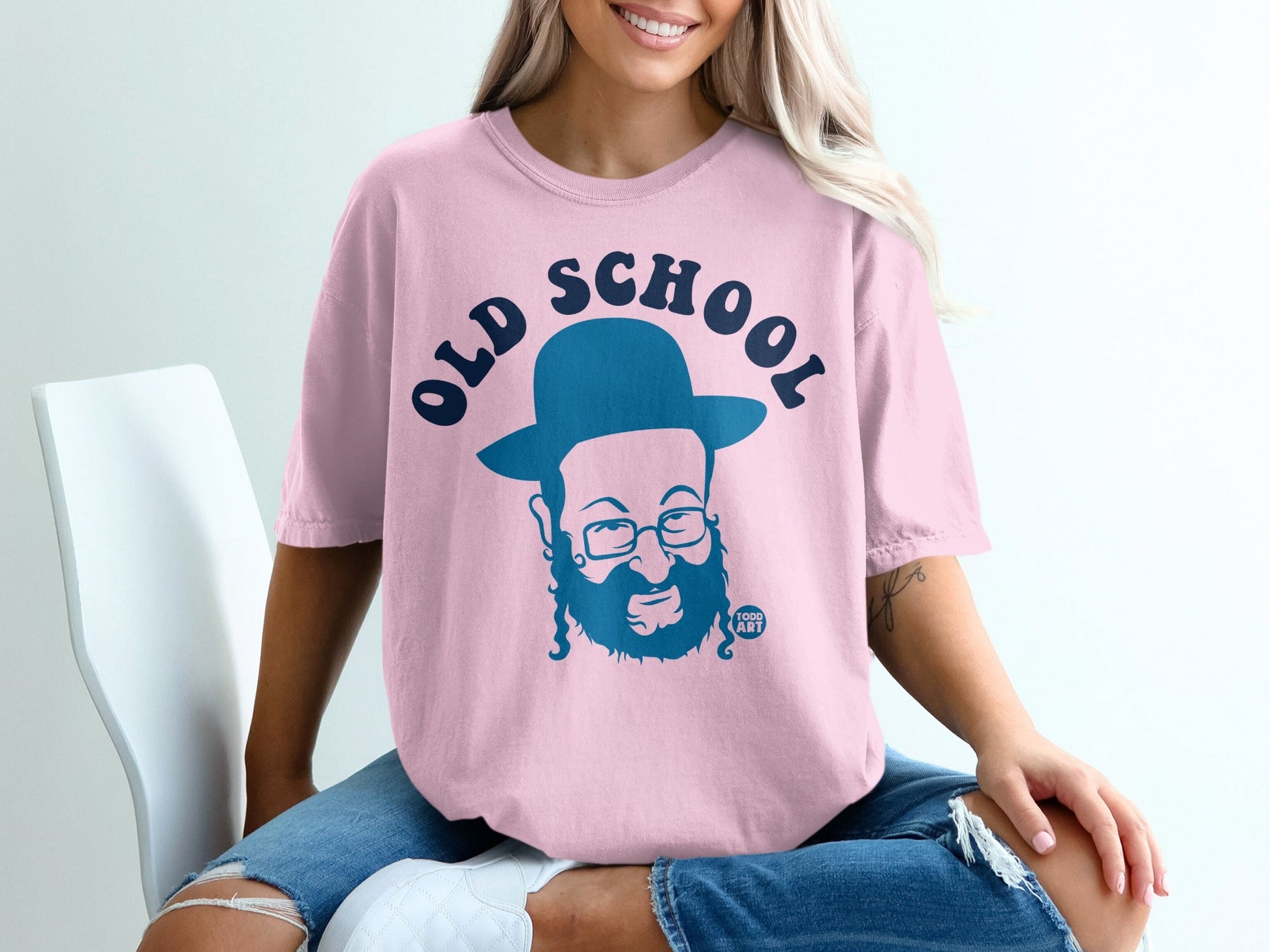 Pink t-shirt with blue "OLD SCHOOL" text and a cartoon man wearing a hat.