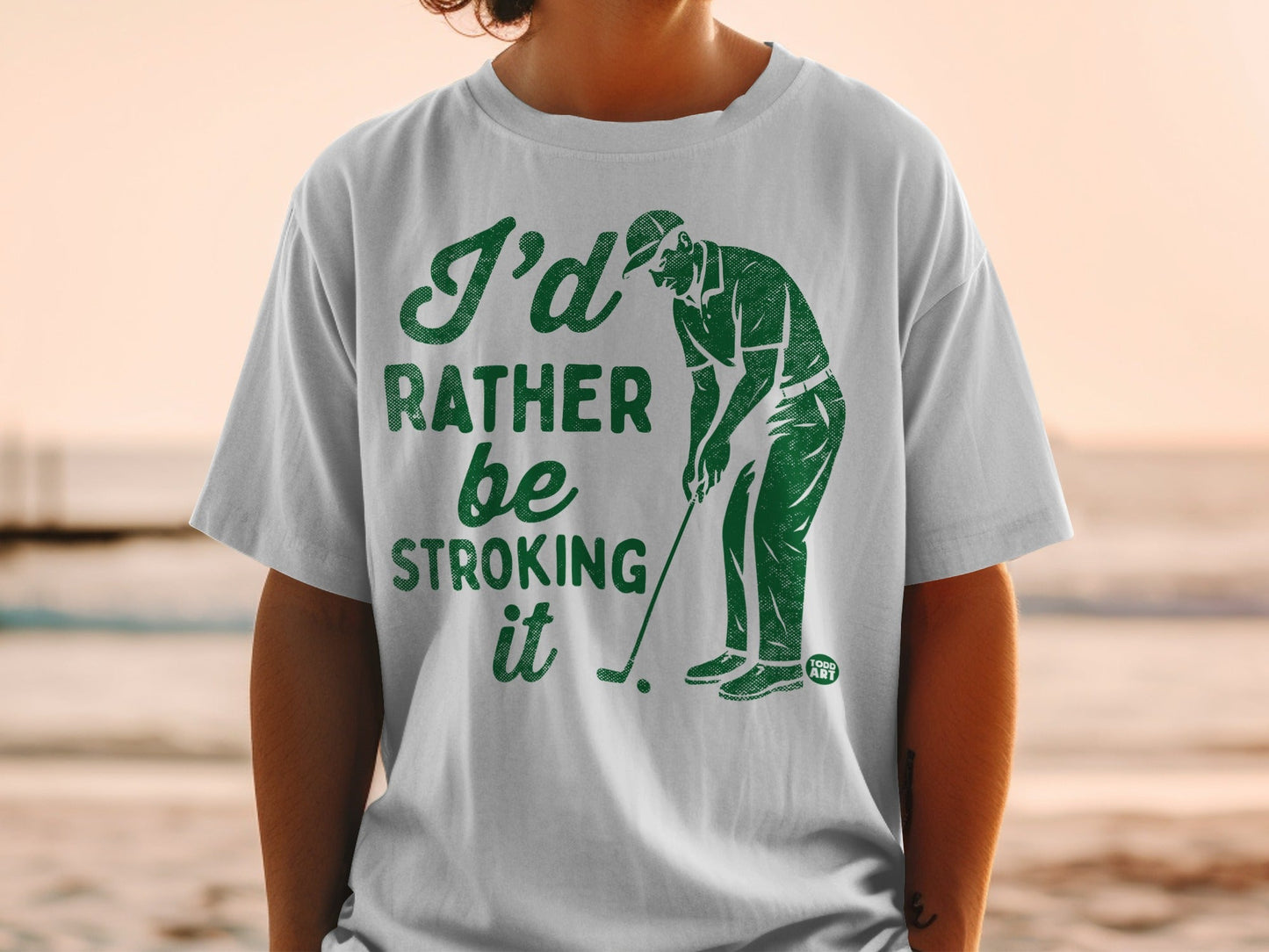 Green t-shirt with "I'd Rather Be Stroking It" golf graphic.