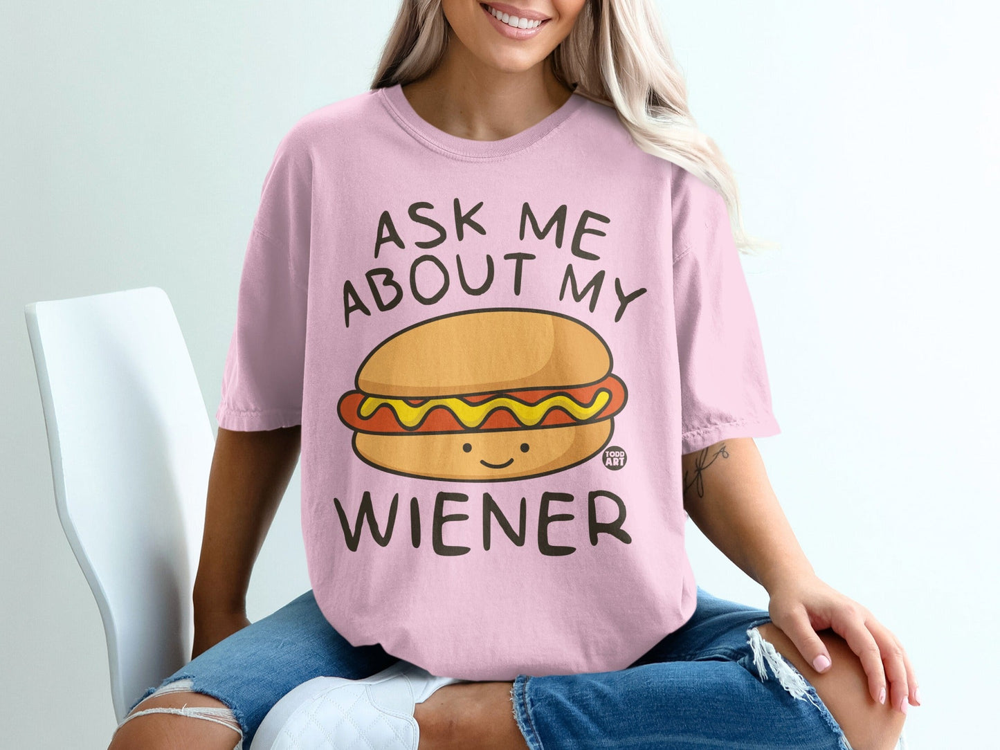 Pink t-shirt with "Ask Me About My Wiener" text and a cartoon hot dog.