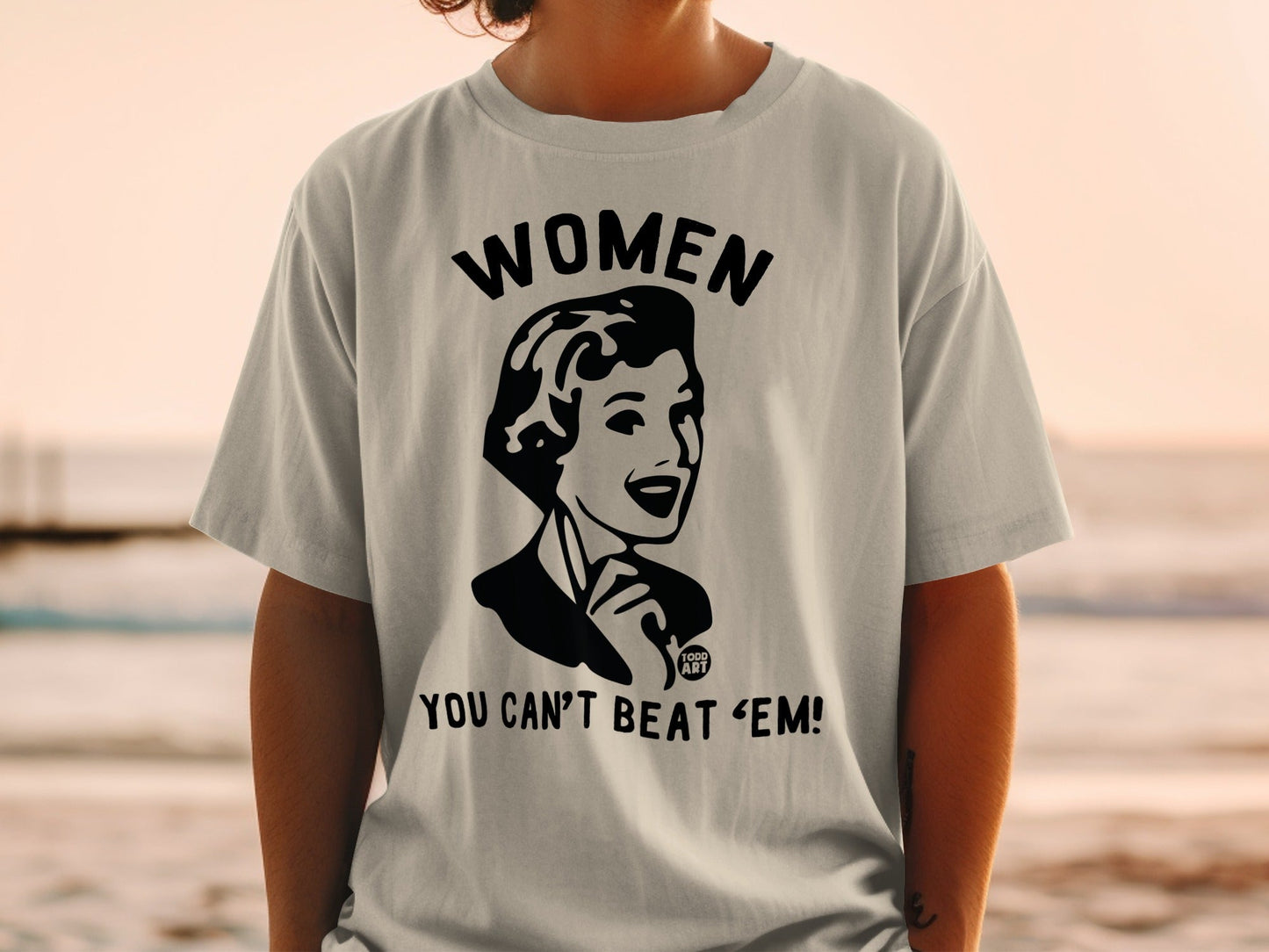 T-shirt with "WOMEN YOU CAN'T 'BEAT 'EM!" graphic of a woman.