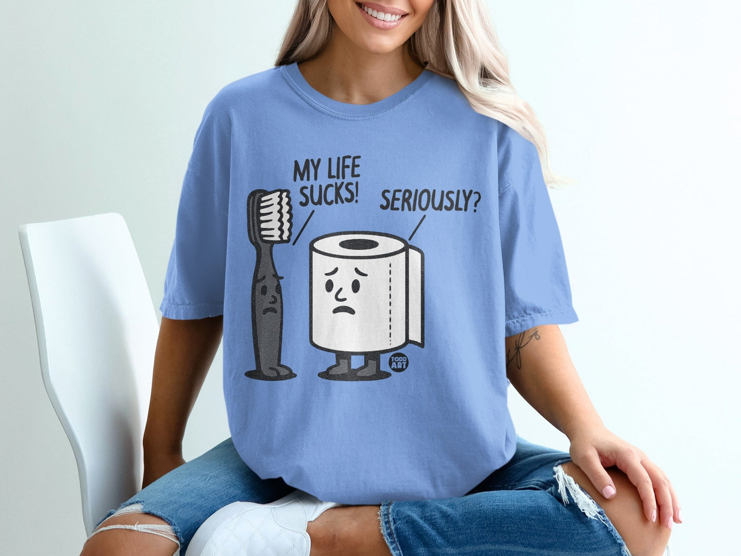 T-shirt graphic of sad toothbrush and toilet paper with text "MY LIFE SUCKS! SERIOUSLY?".