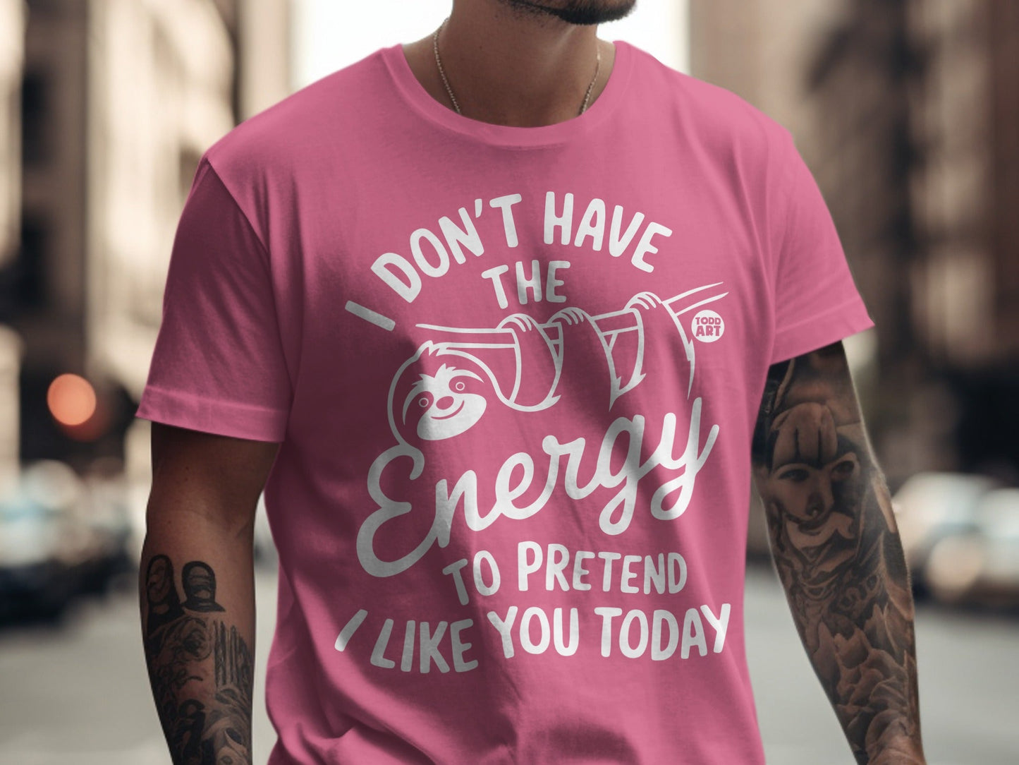 Pink t-shirt with white text and a sloth graphic saying "I don't have the energy to pretend I like you today".