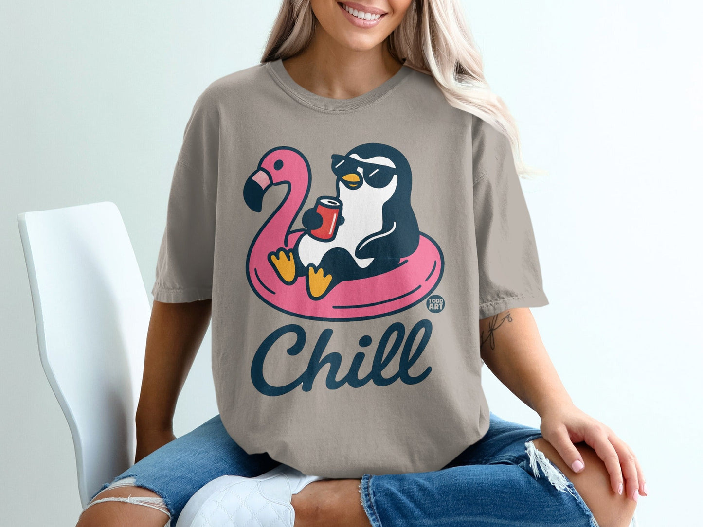 Penguin wearing sunglasses floats on flamingo inner tube, holding a drink.