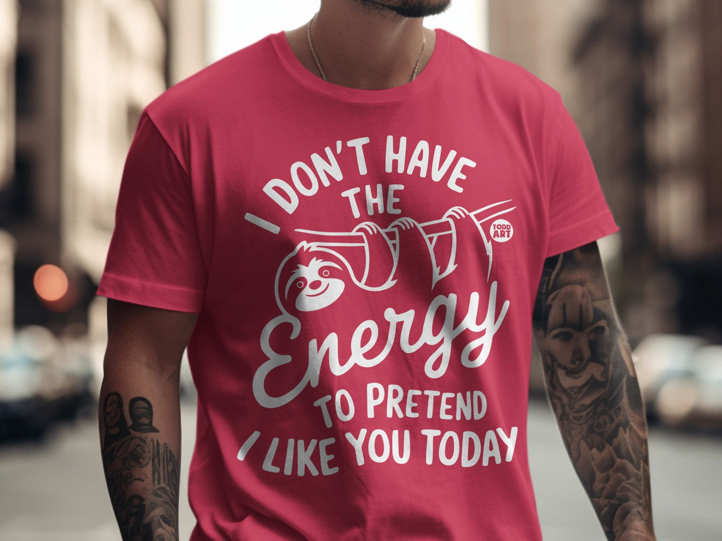 Pink t-shirt with white text and a sloth graphic saying "I don't have the energy to pretend I like you today."