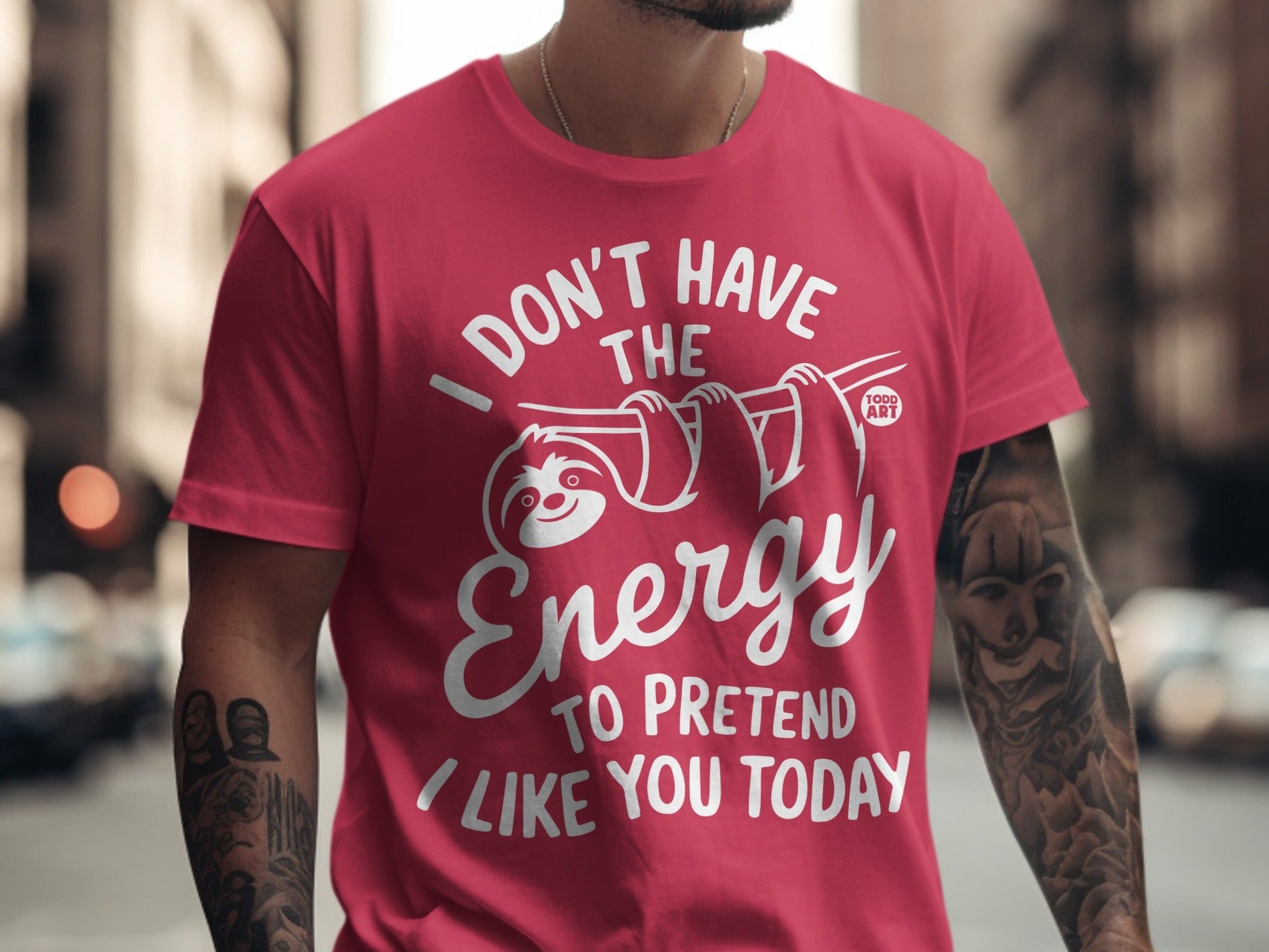 Pink t-shirt with white text and a sloth graphic saying "I don't have the energy to pretend I like you today."