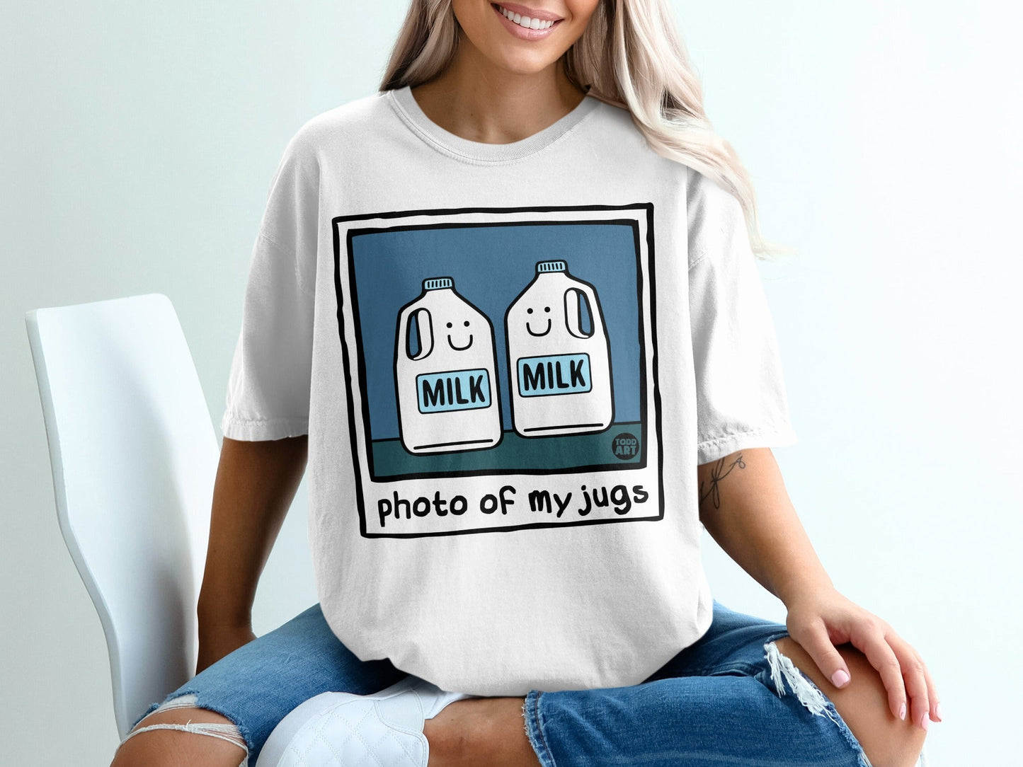 White t-shirt with cartoon milk jugs and "photo of my jugs" text.