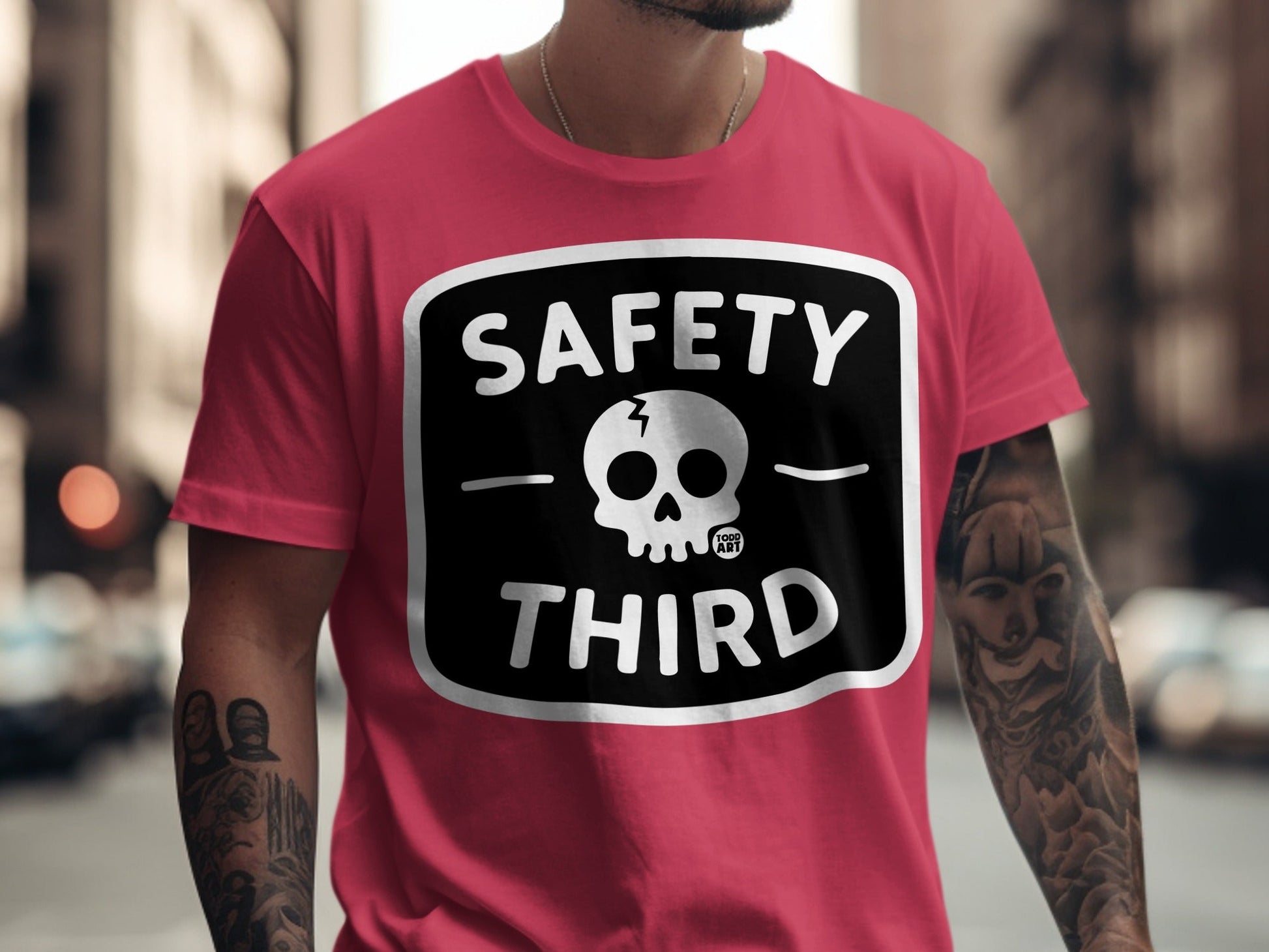 Pink t-shirt with "SAFETY THIRD" text and skull graphic.