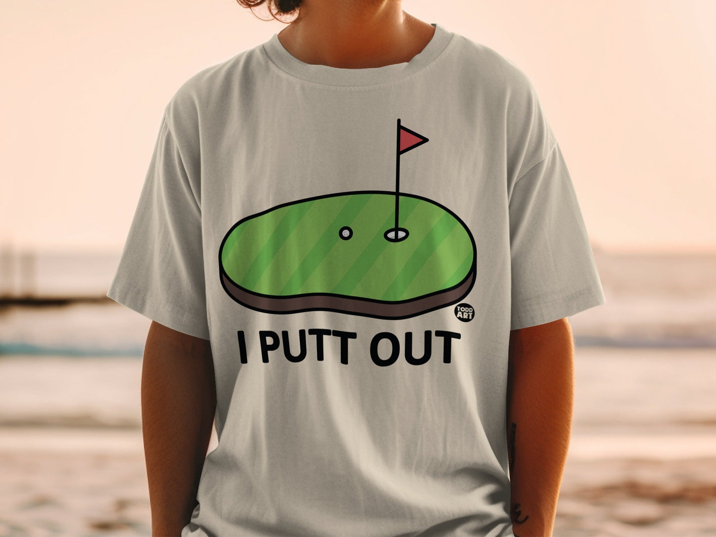 Gray t-shirt with "I PUTT OUT" text and golf green graphic.