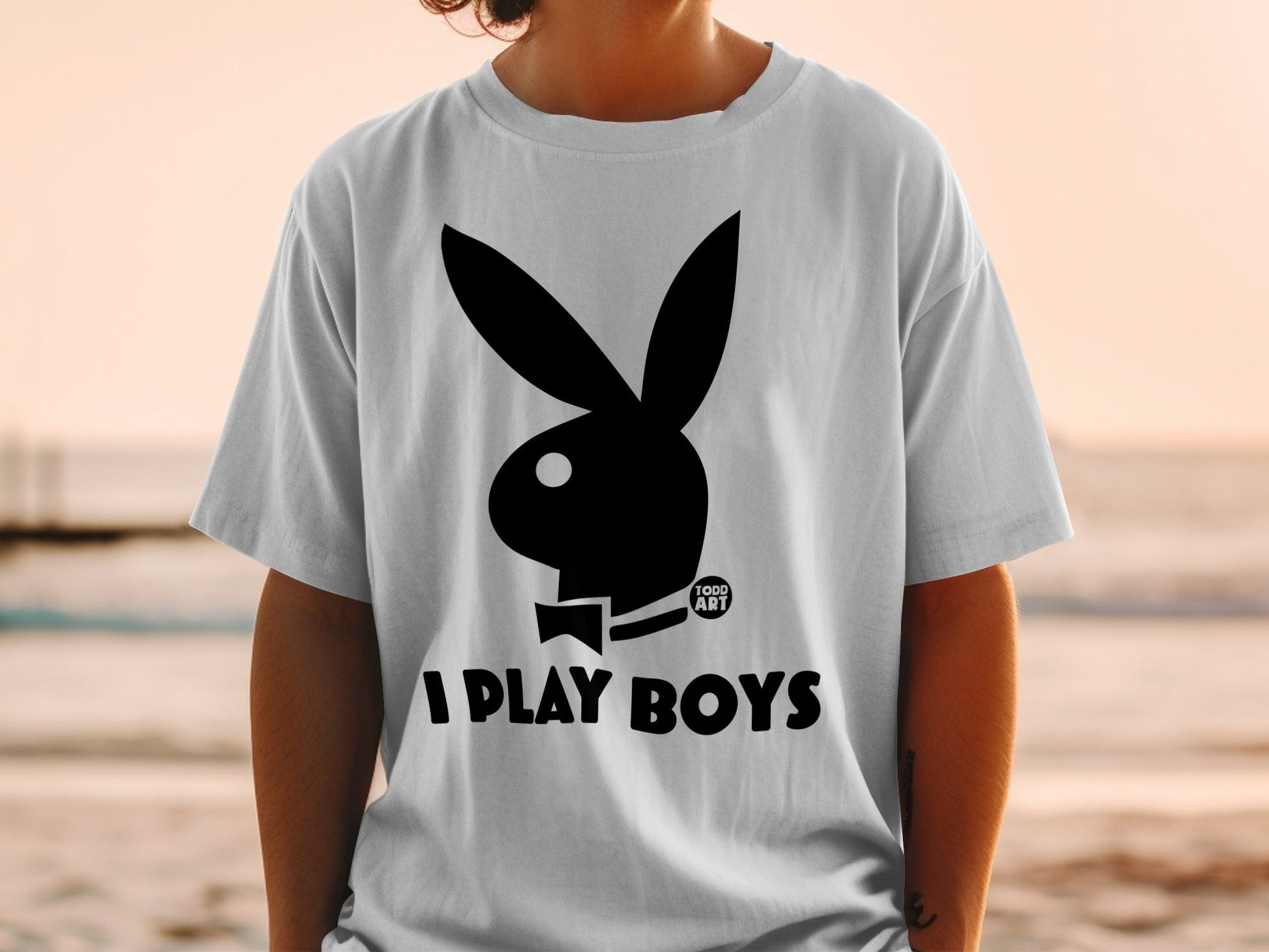White t-shirt with black Playboy bunny logo and "I PLAY BOYS TODD ART" text.