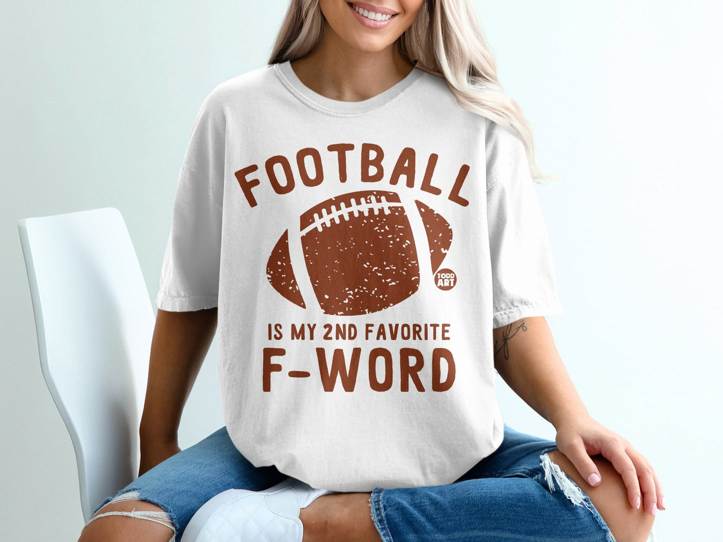 White t-shirt with "FOOTBALL IS MY 2ND FAVORITE F-WORD" and football graphic.